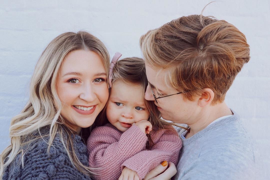 parents kissing toddler