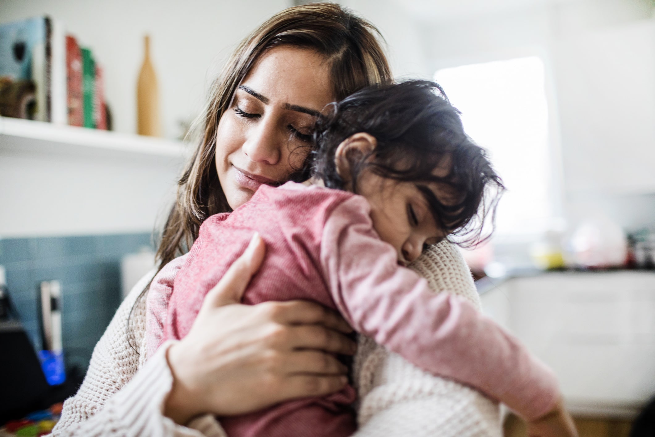 mom hugging toddler