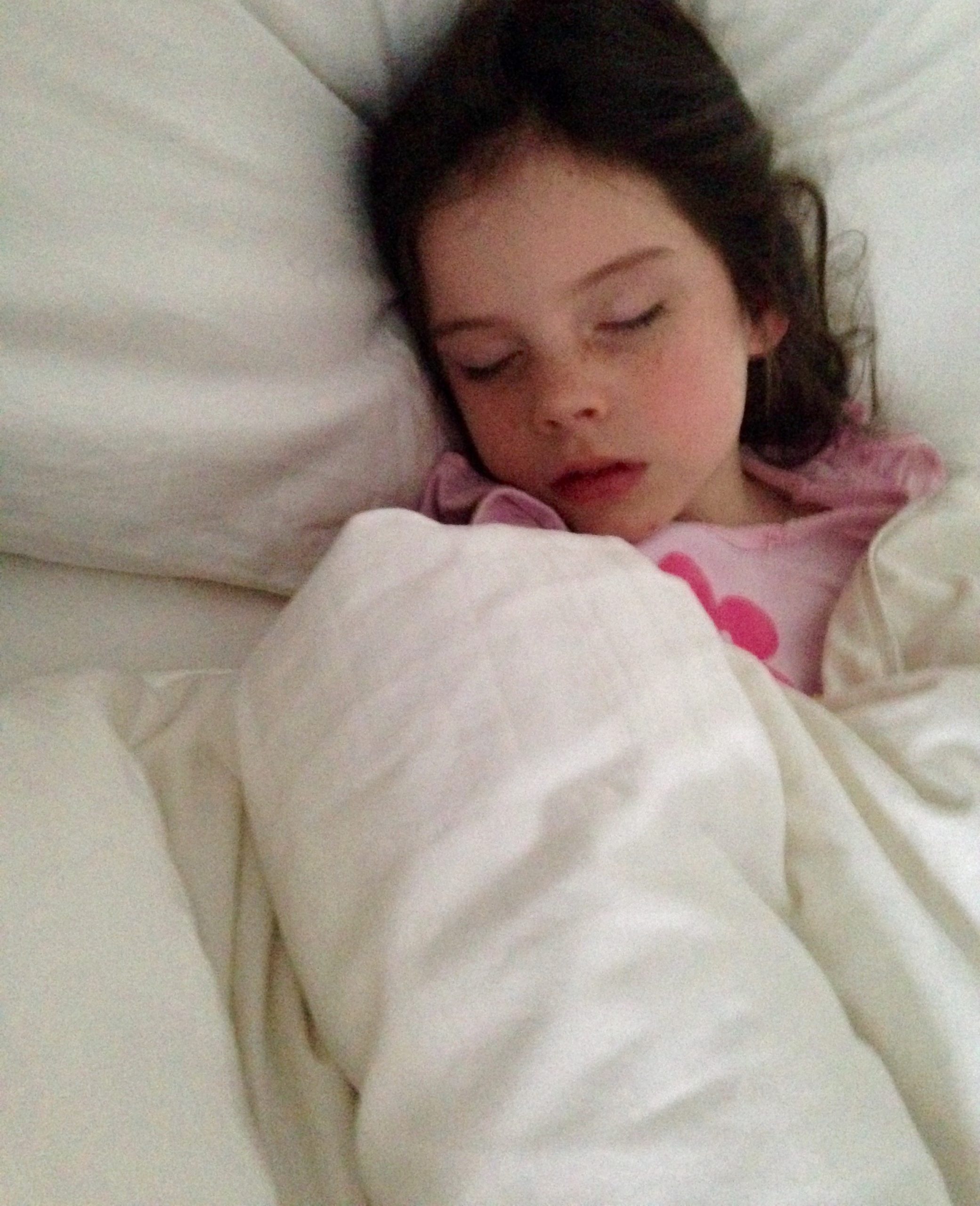 little girl sleeping in a bed