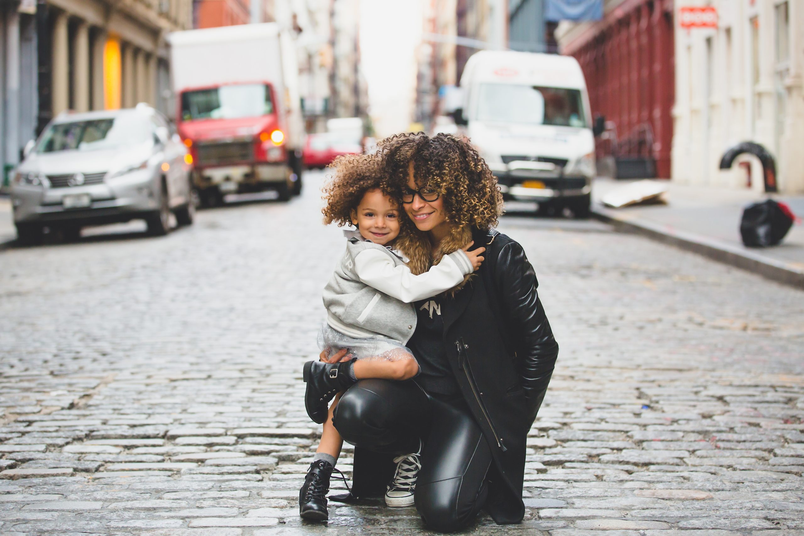 mom and daughter hugging on the street