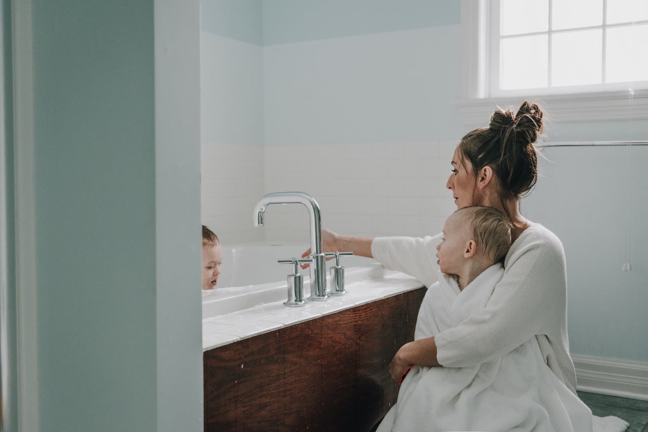 mom hugging child before a bath