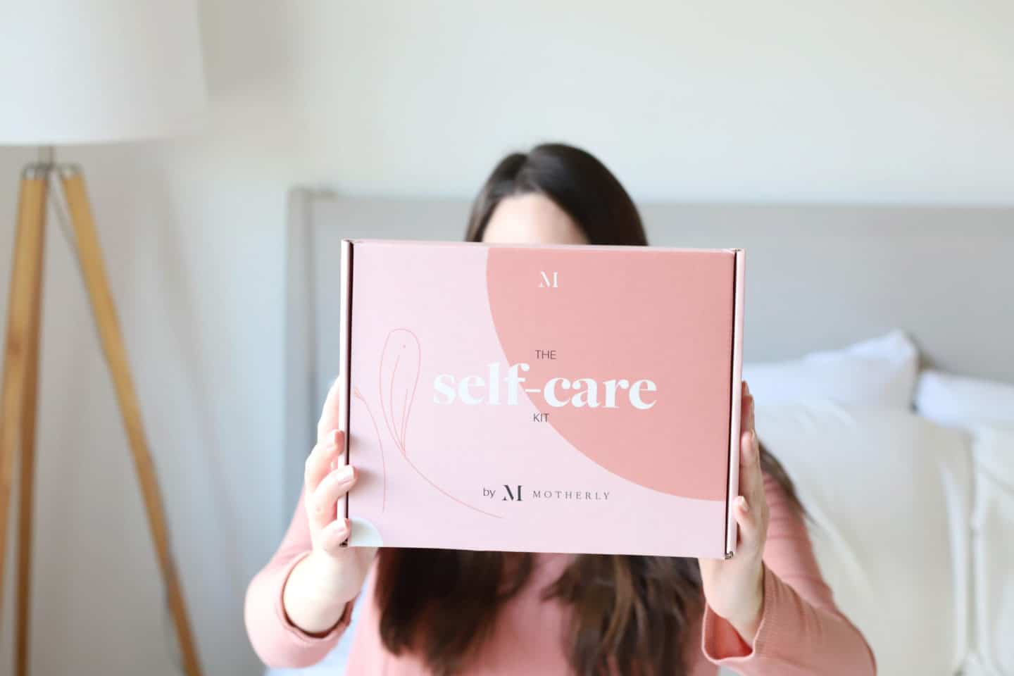 woman holding self-care kit