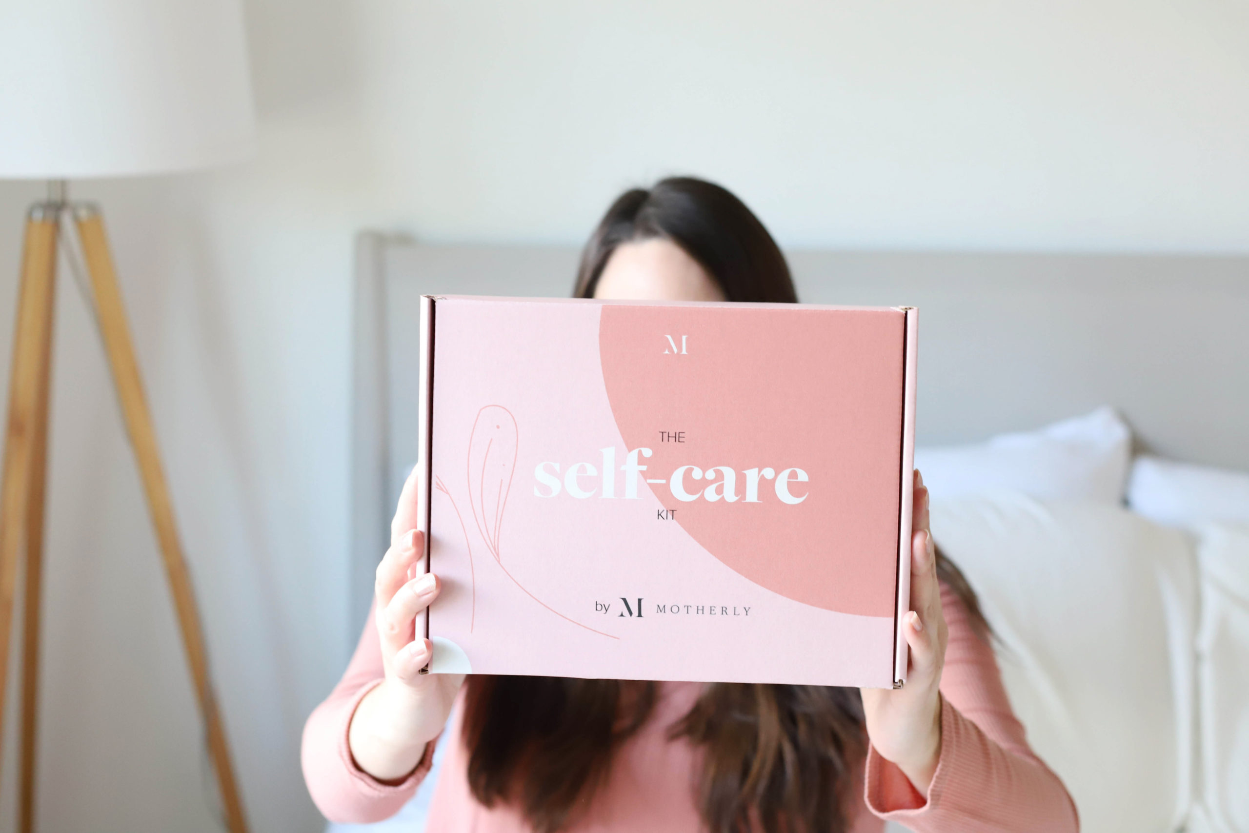woman holding self-care kit