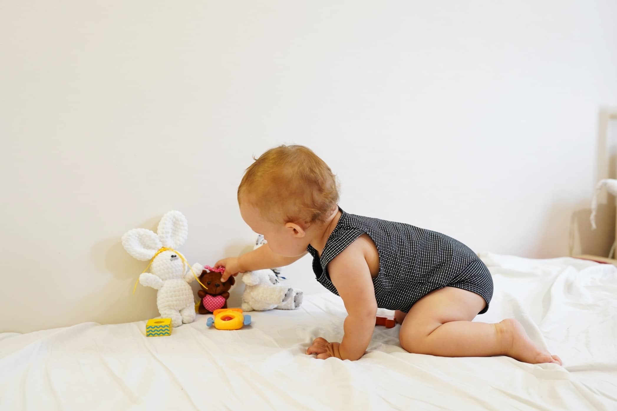 baby playing with toys in a crawling position