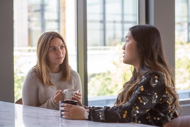 two women talking over coffee