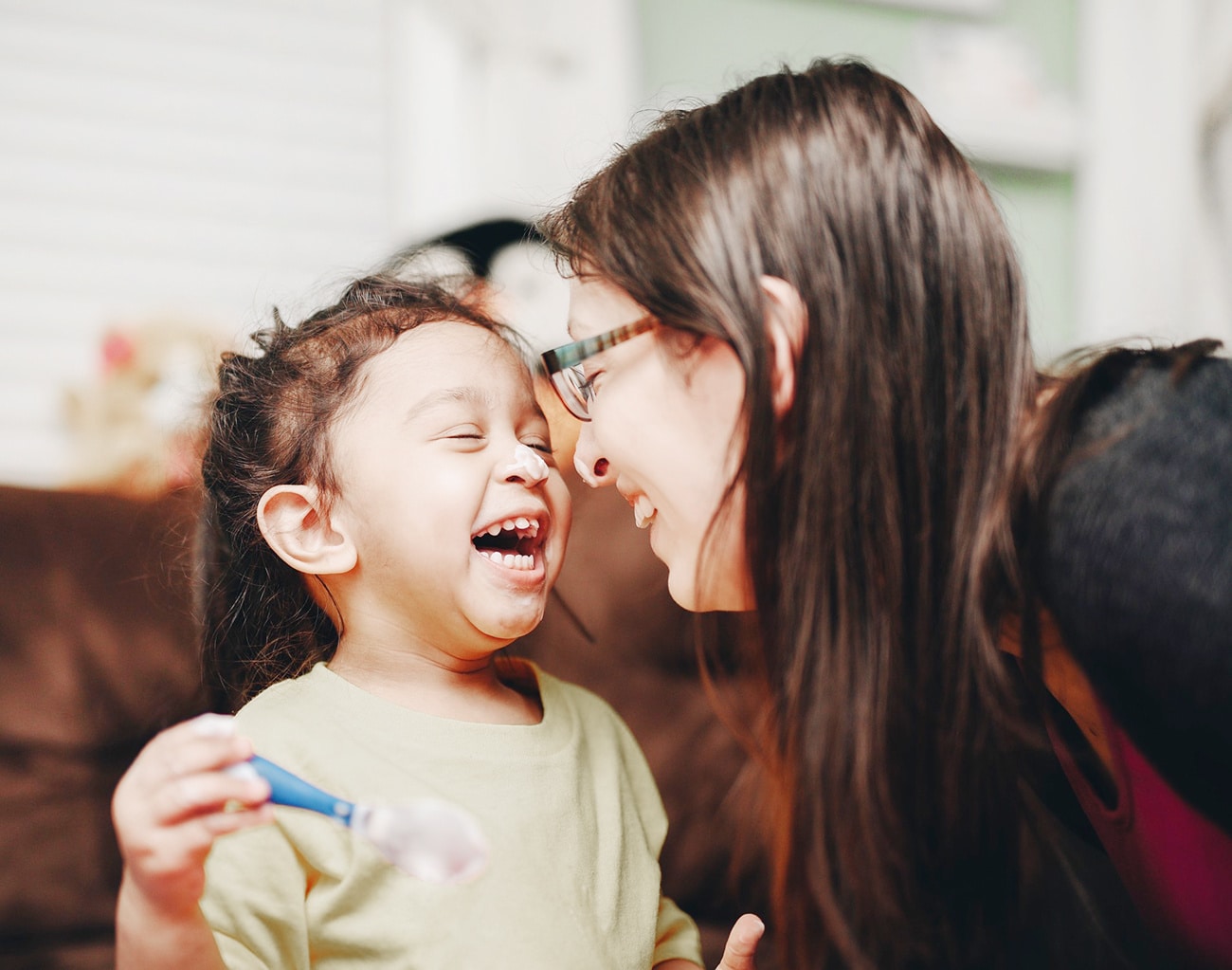 mom laughing with toddler