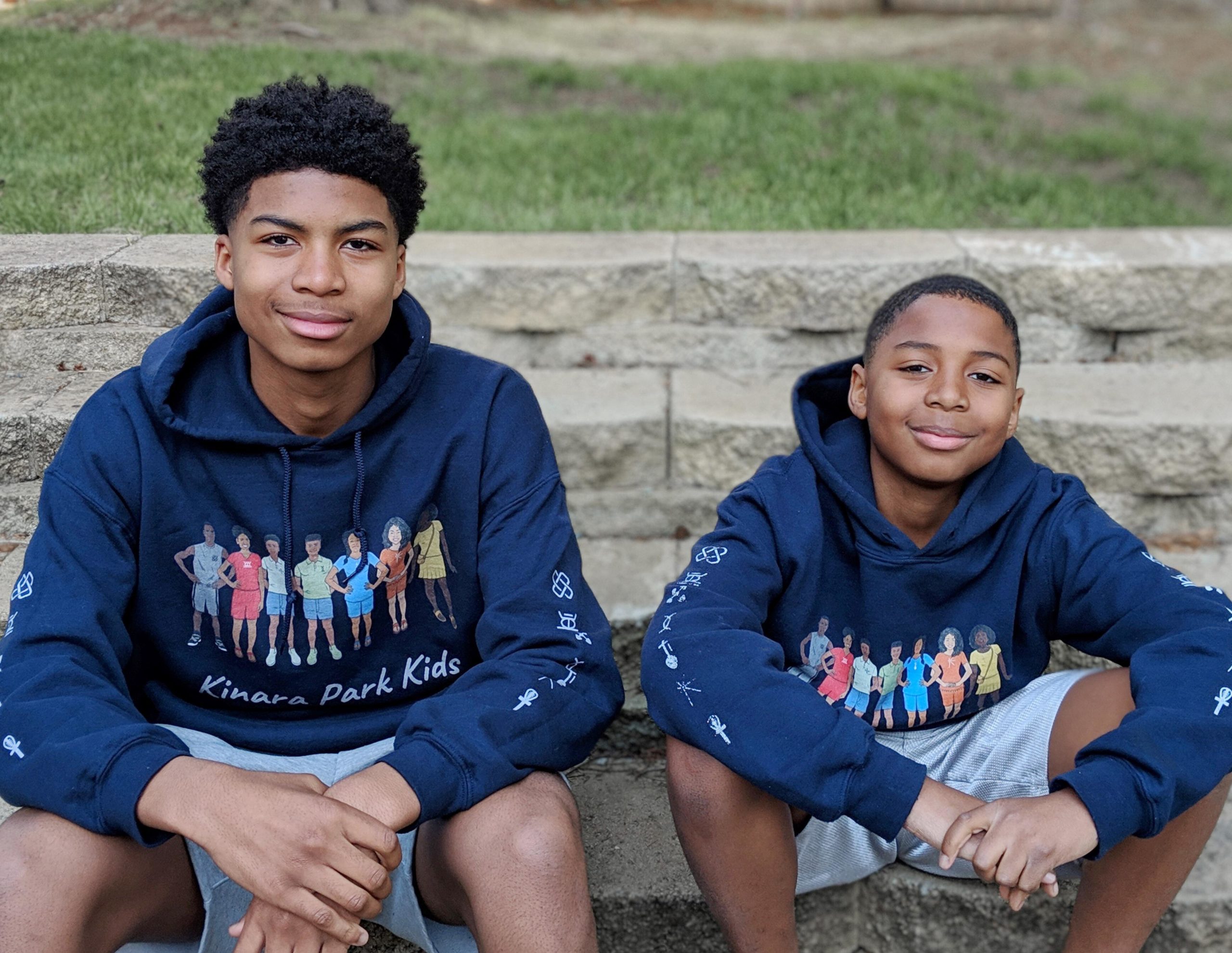 two children wearing kinara park sweaters- 7 principles of kwanzaa