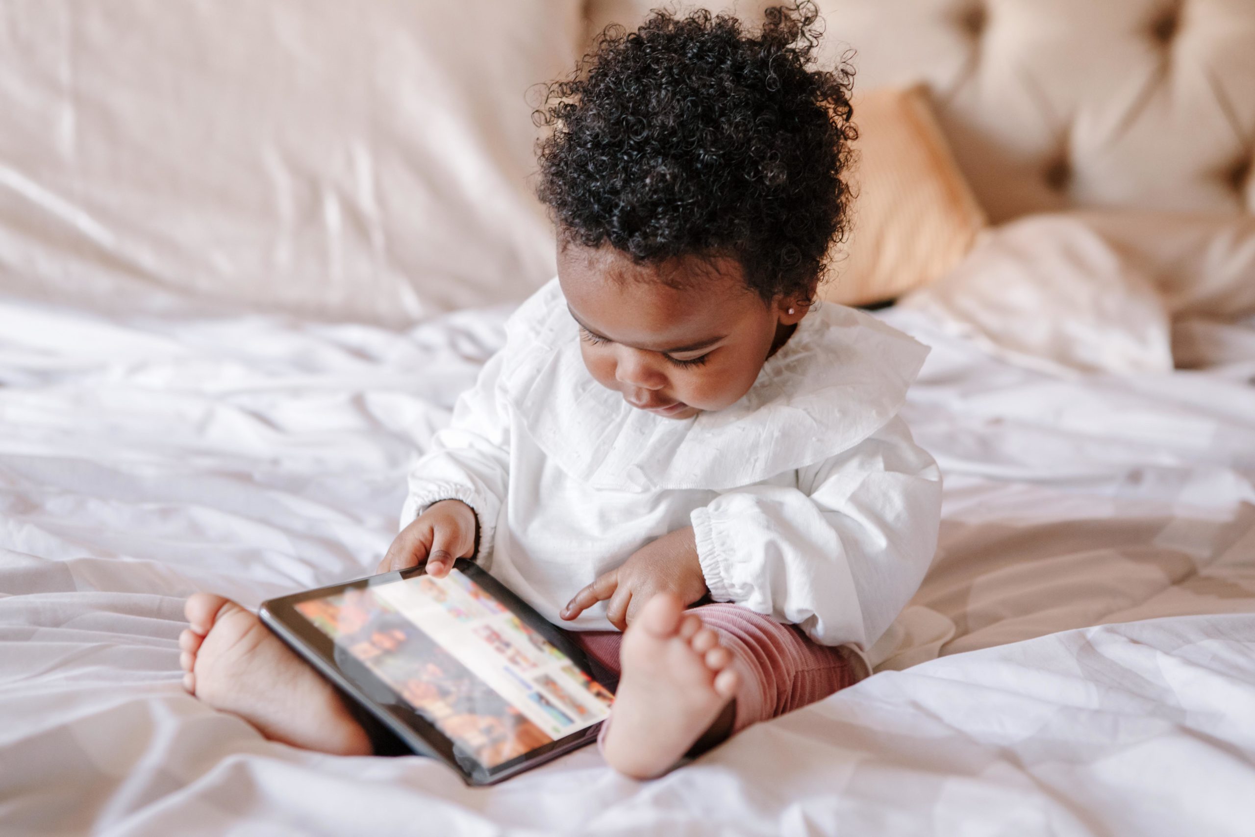 baby playing on a tablet