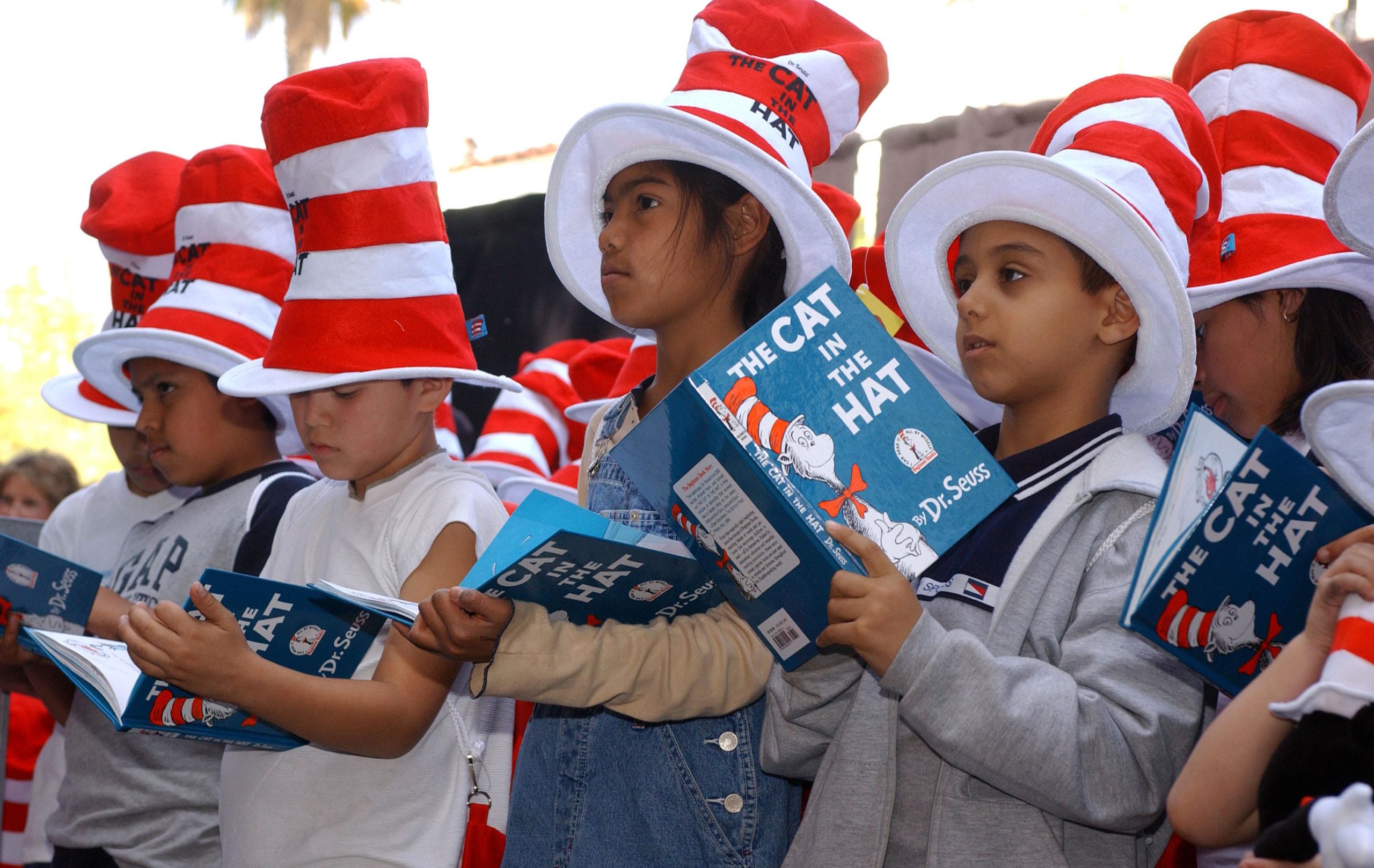 Kids dressed as Dr. Seuss characters with books in hand