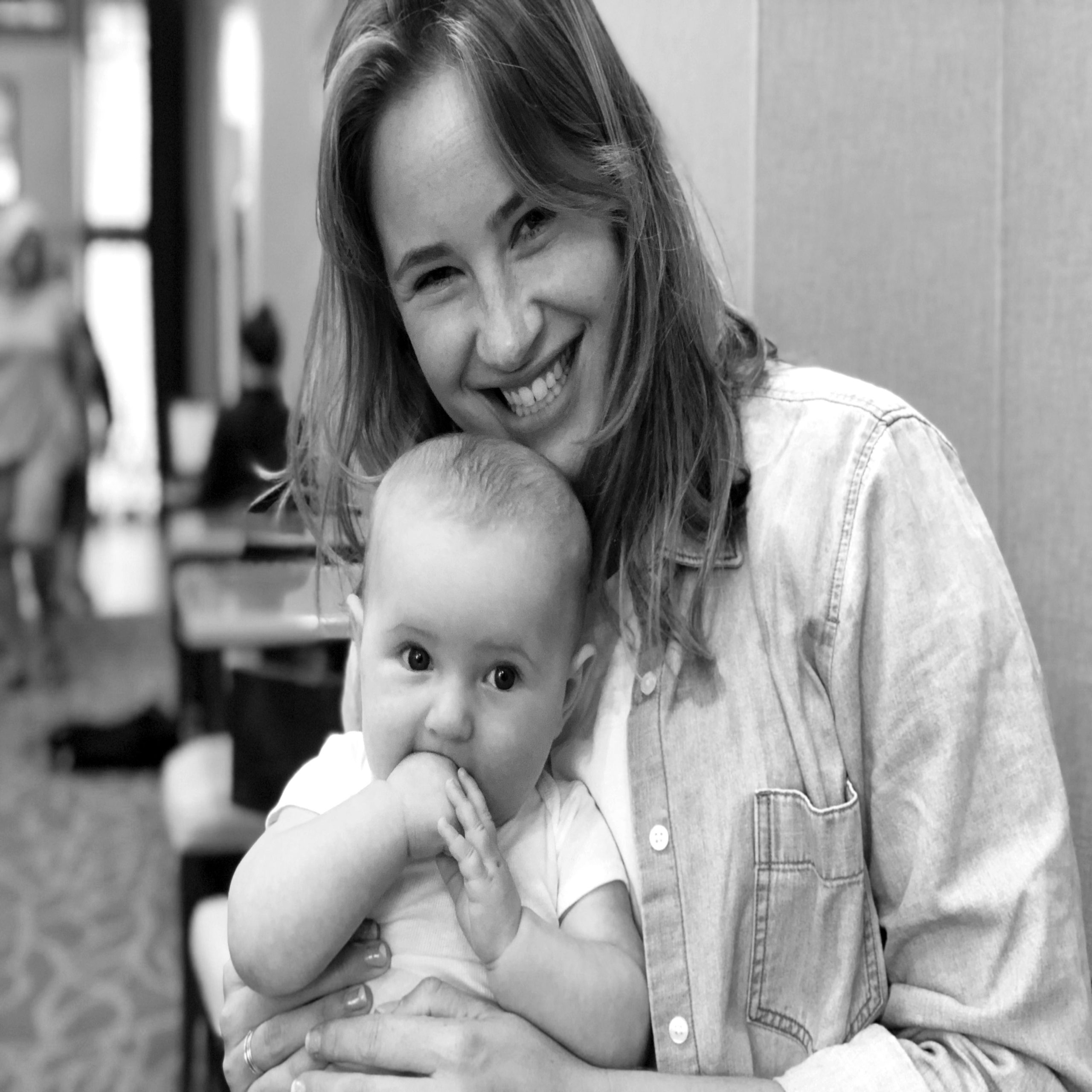 mom smiling while holding newborn