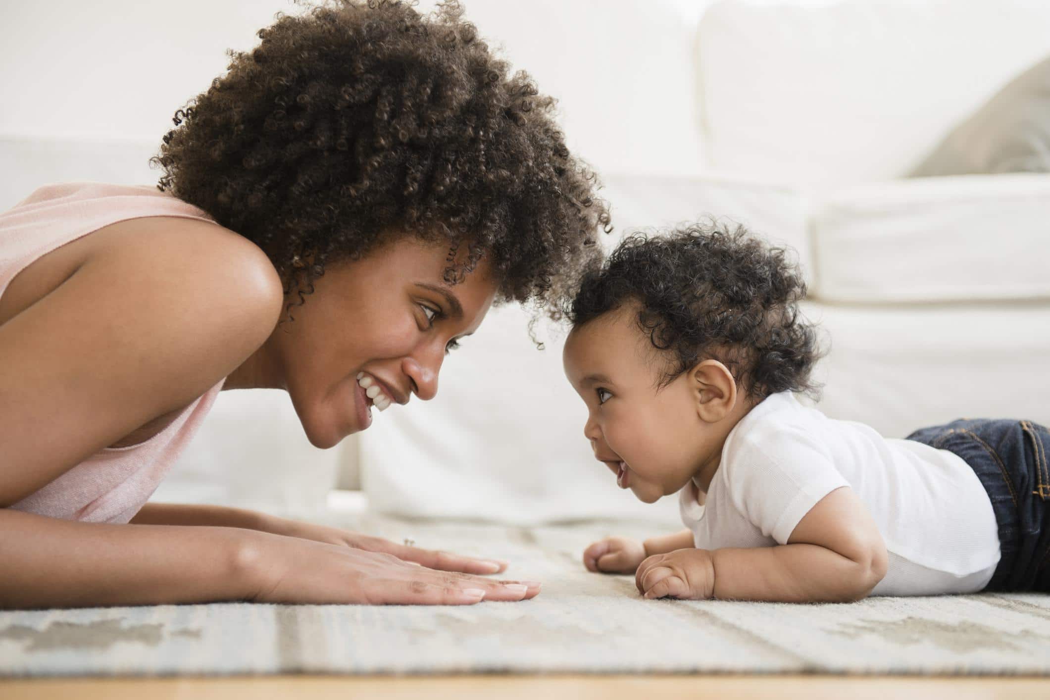 mom doing tummy time with baby on motherly's favorite living room play mat from the house of noa