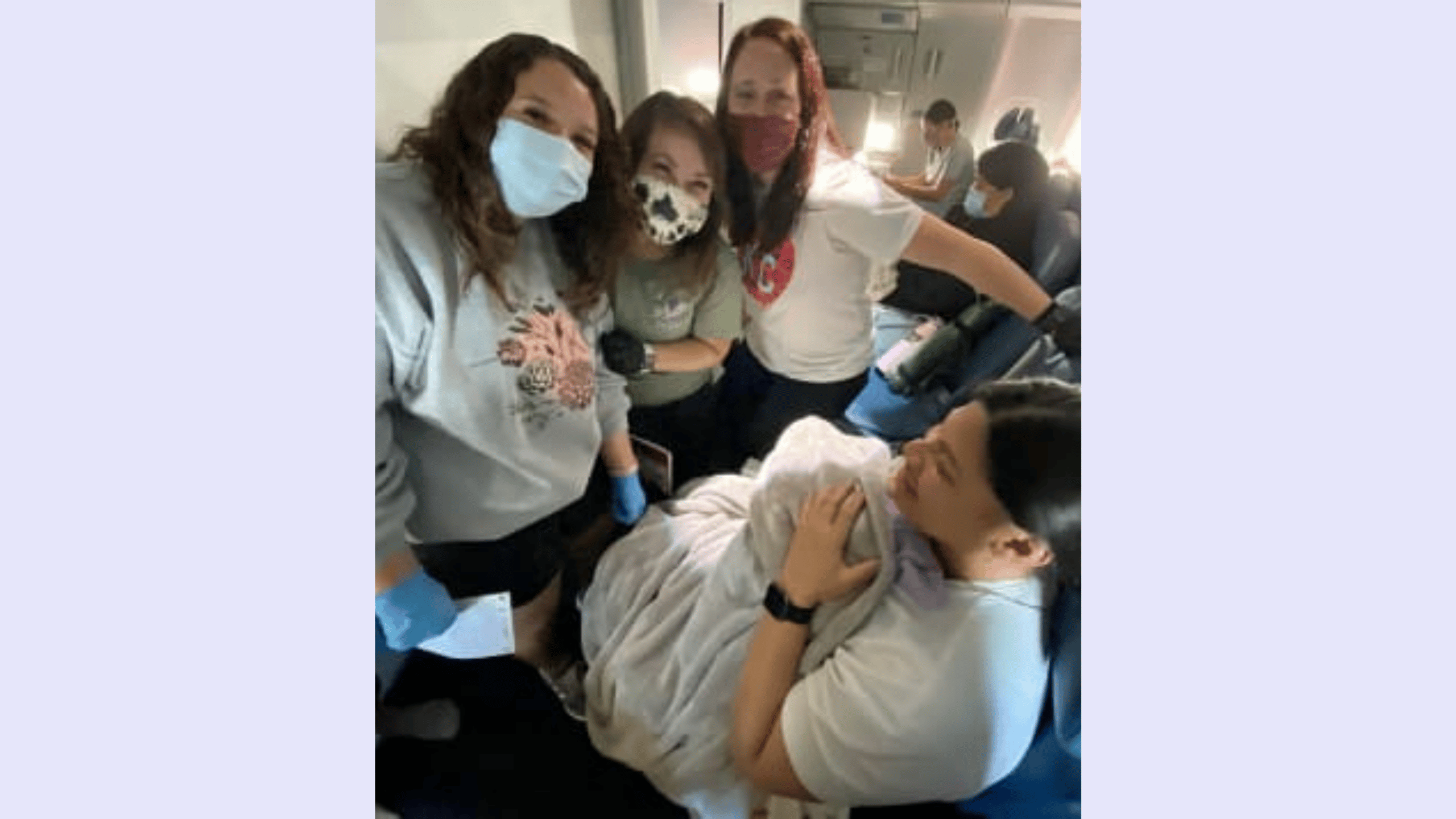 mother holding newborn baby on a plane