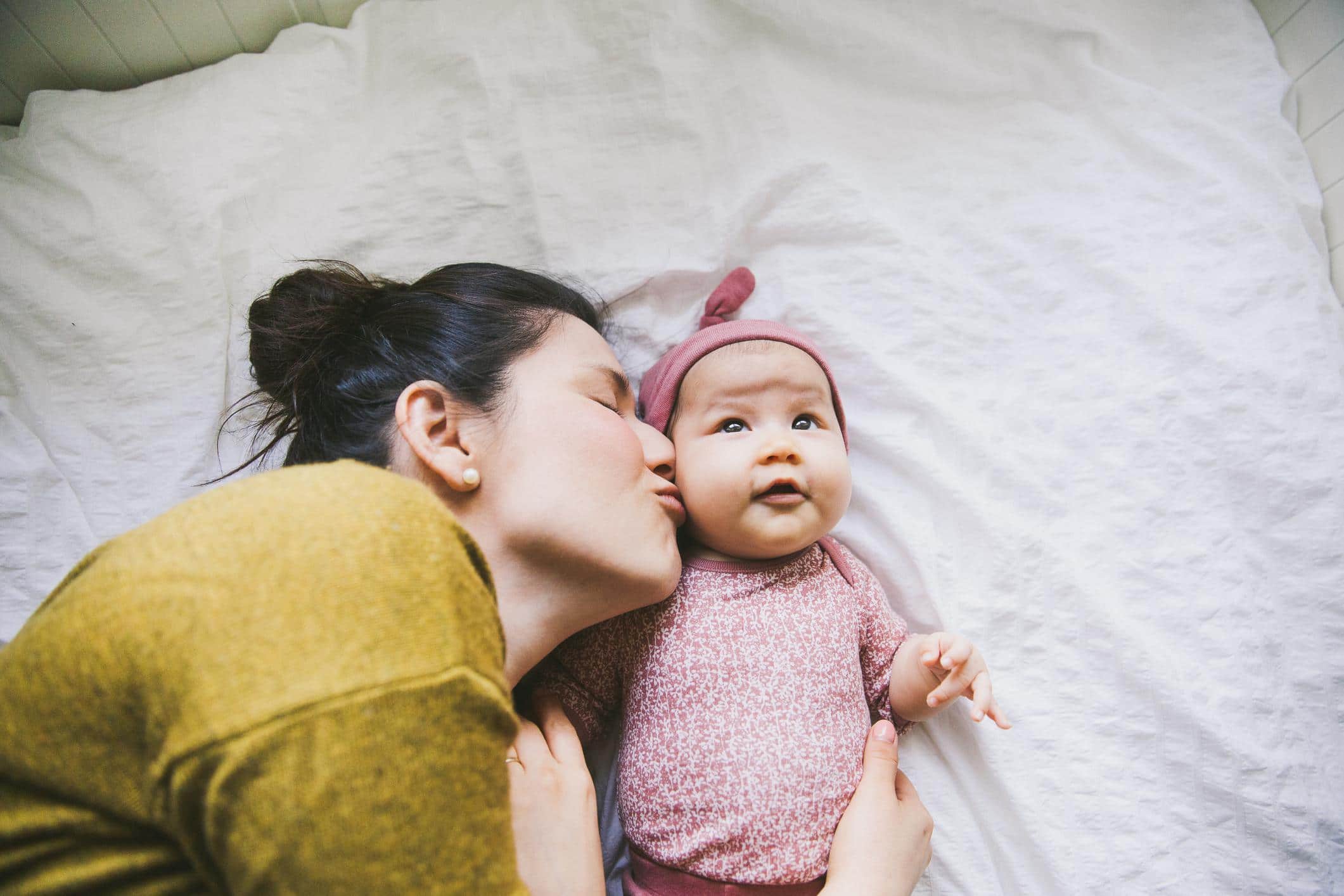 mom kissing baby whose baby girl name starts with K