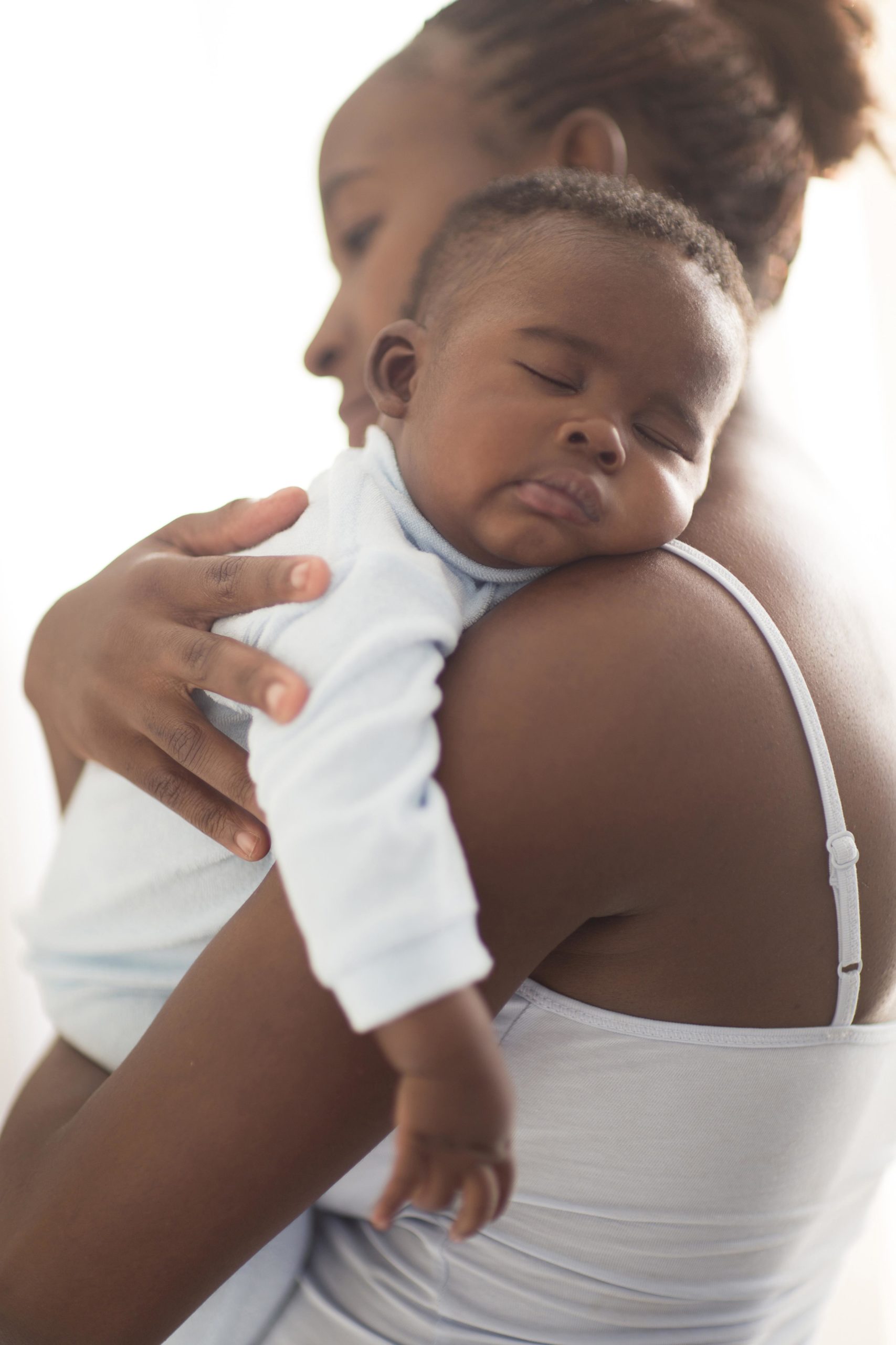 racial disparity: mother holds sleeping infant
