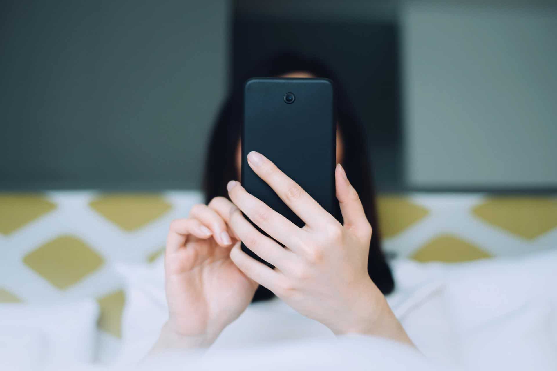 woman with a towel on her head on the phone