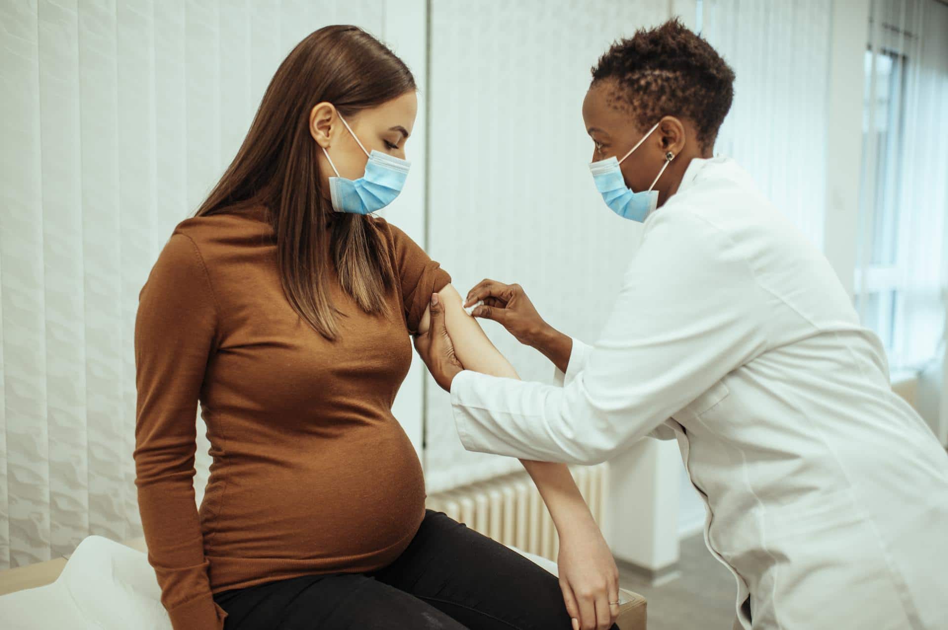 pregnant woman getting a vaccine