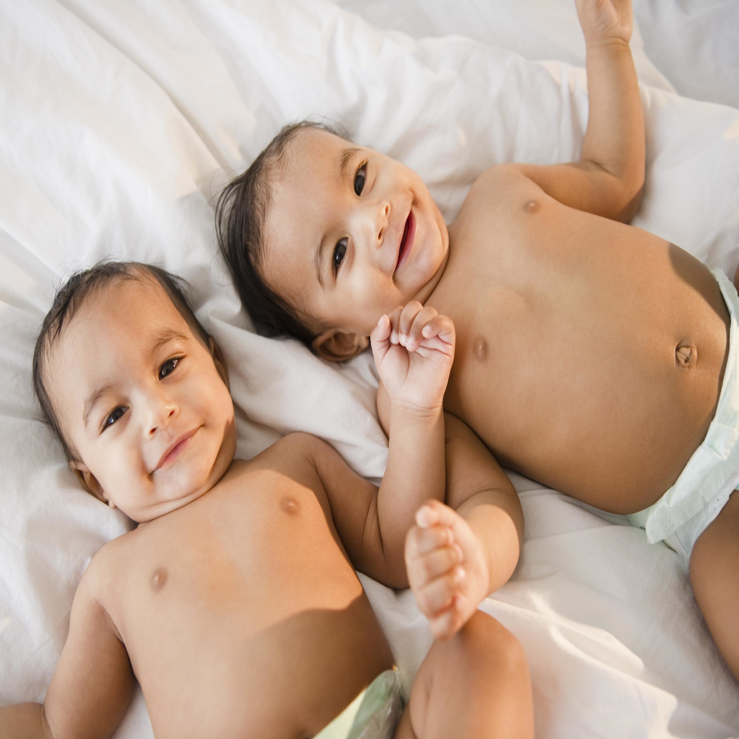 two babies laying in bed