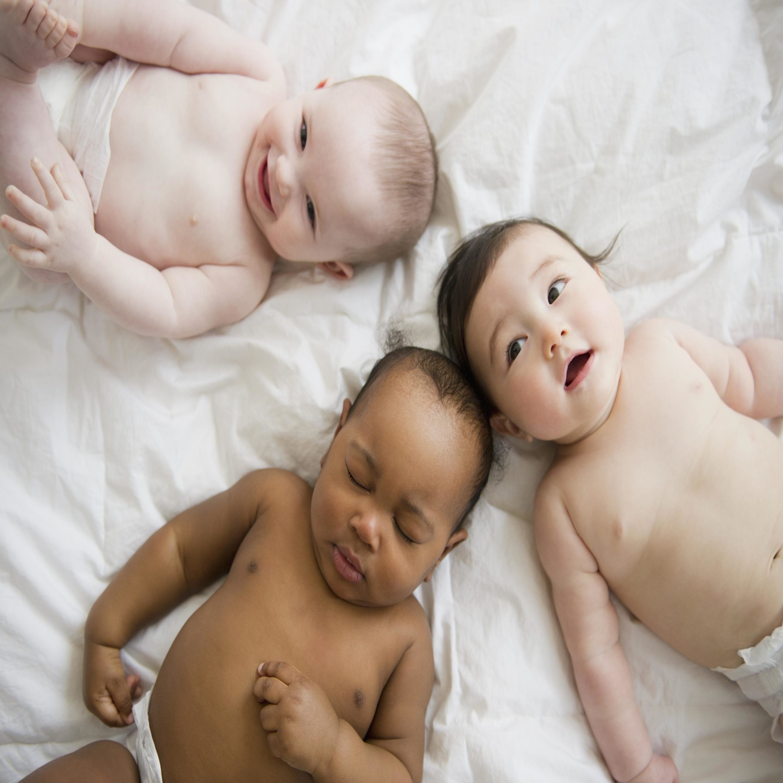 babies laying in a circle wearing nothing but diapers
