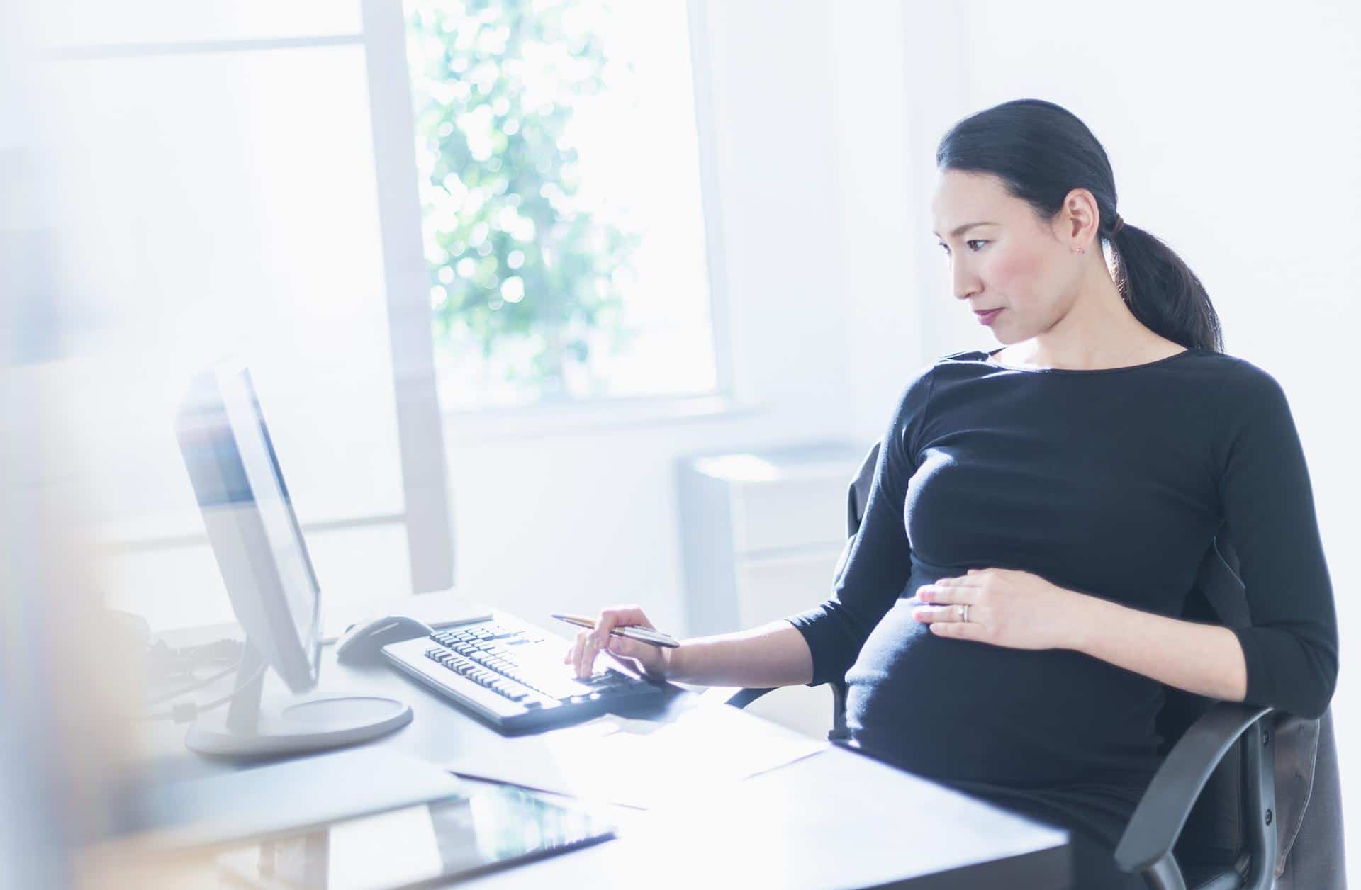 pregnant woman working on a laptop