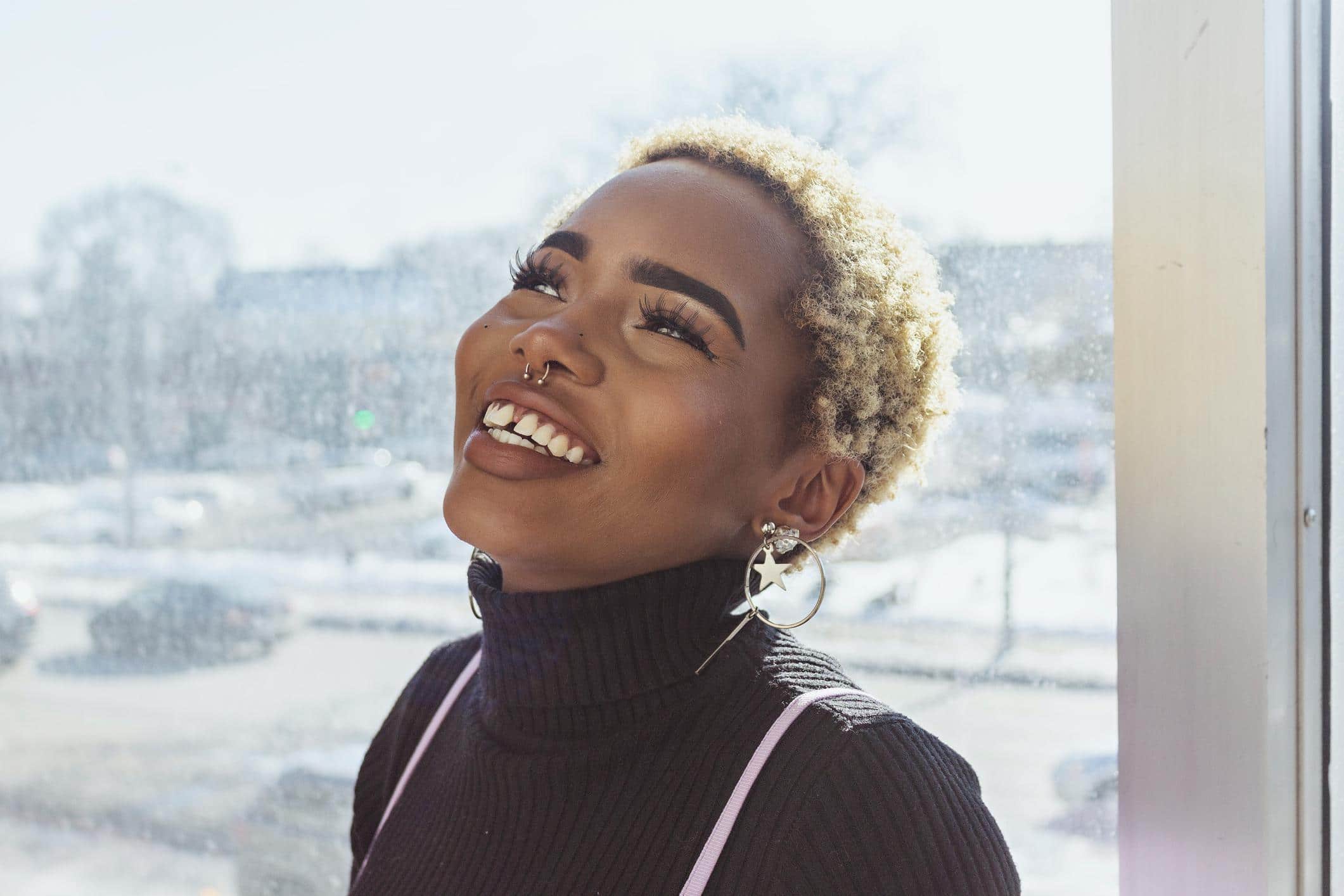 woman smiling by a window - mindfulness exercises