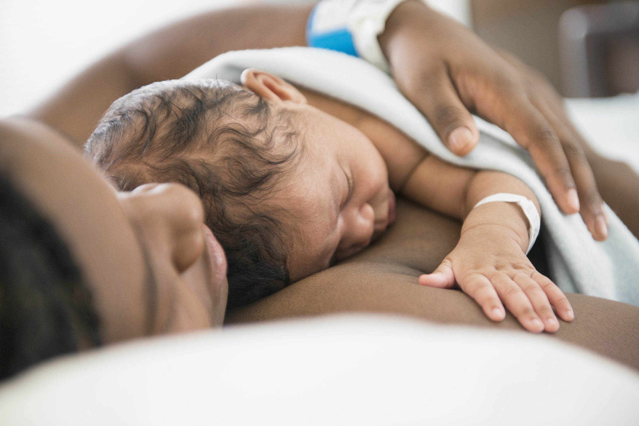 mom hugging baby to chest - birth quotes