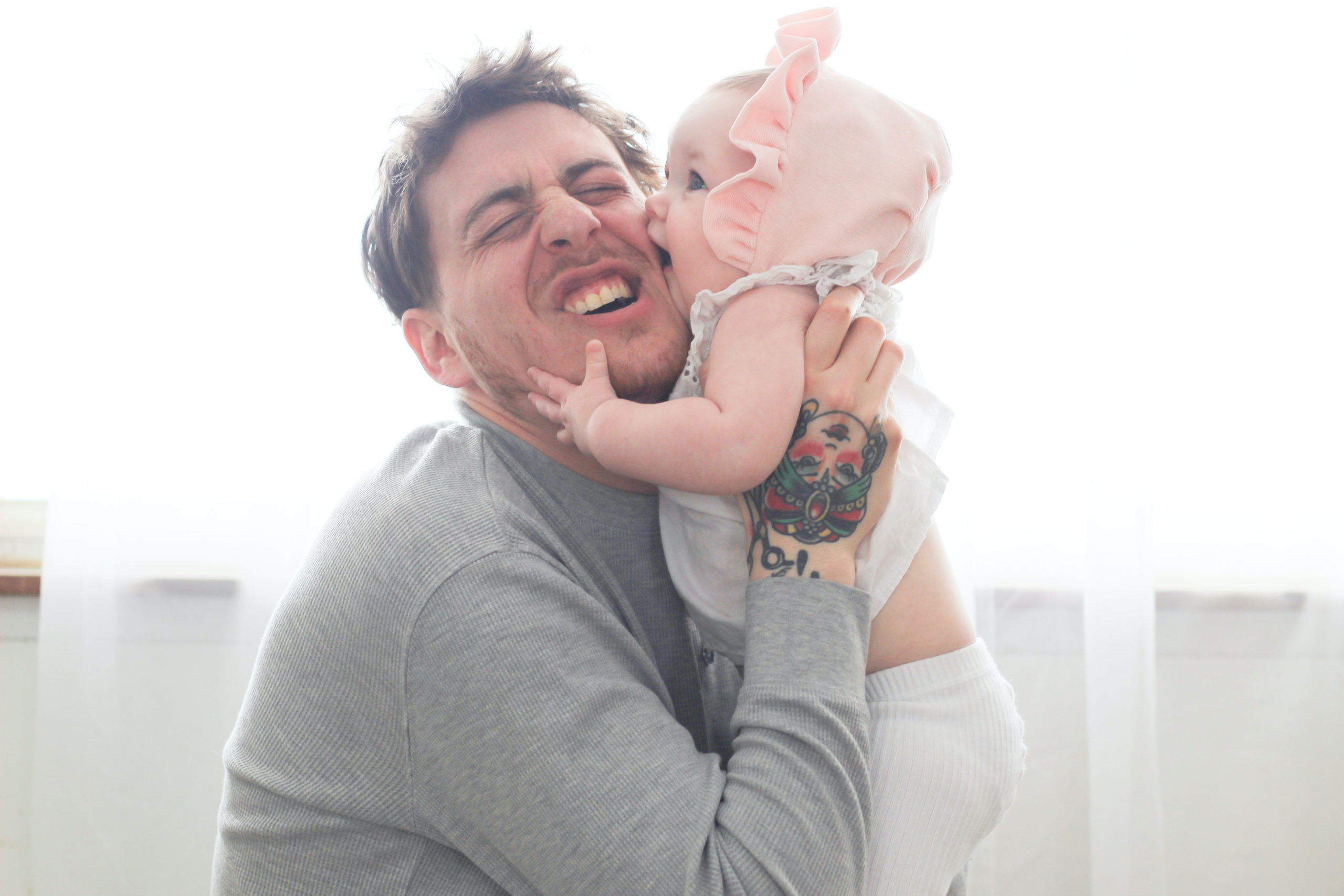 baby kissing dad on the cheek