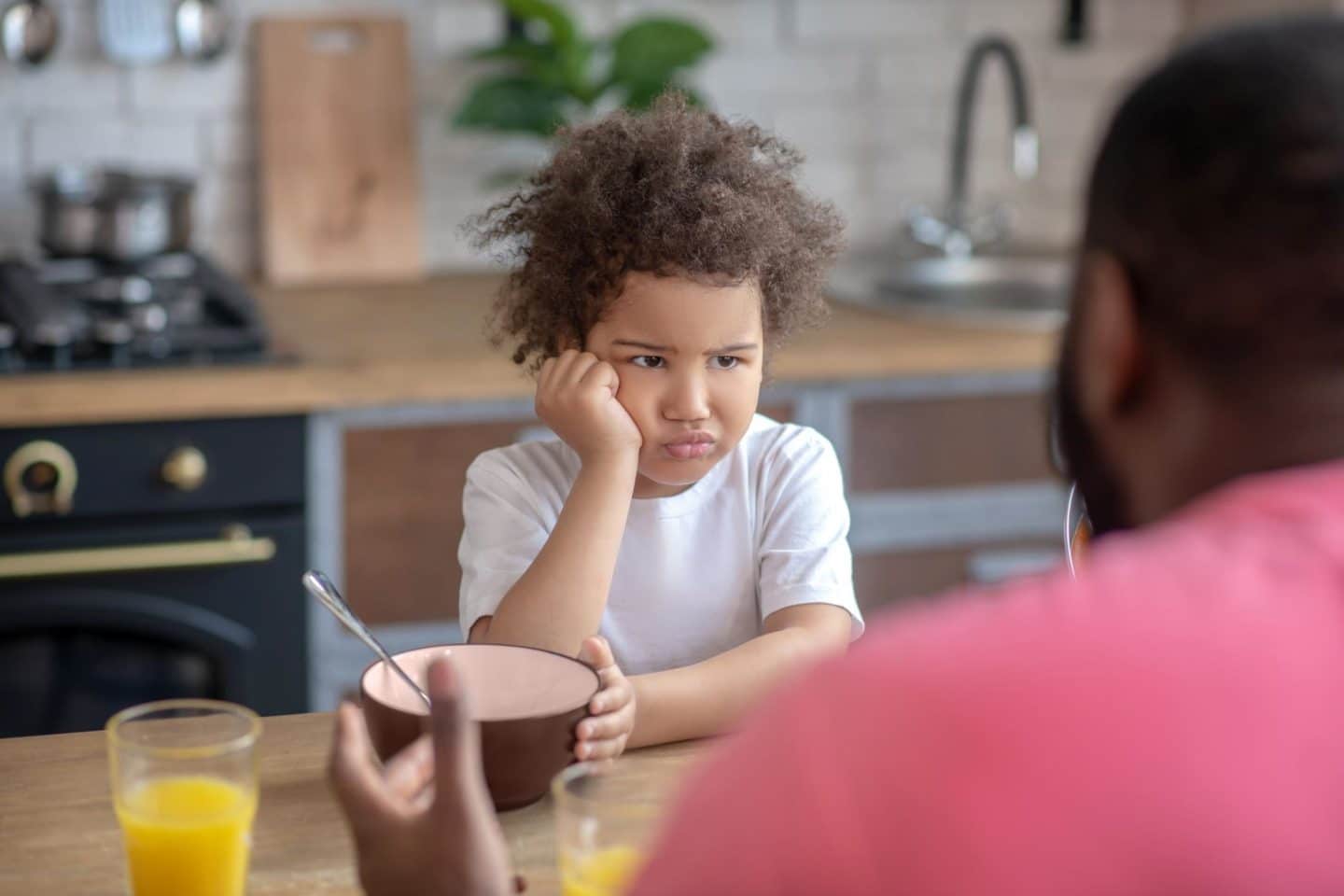 grumpy child at the table