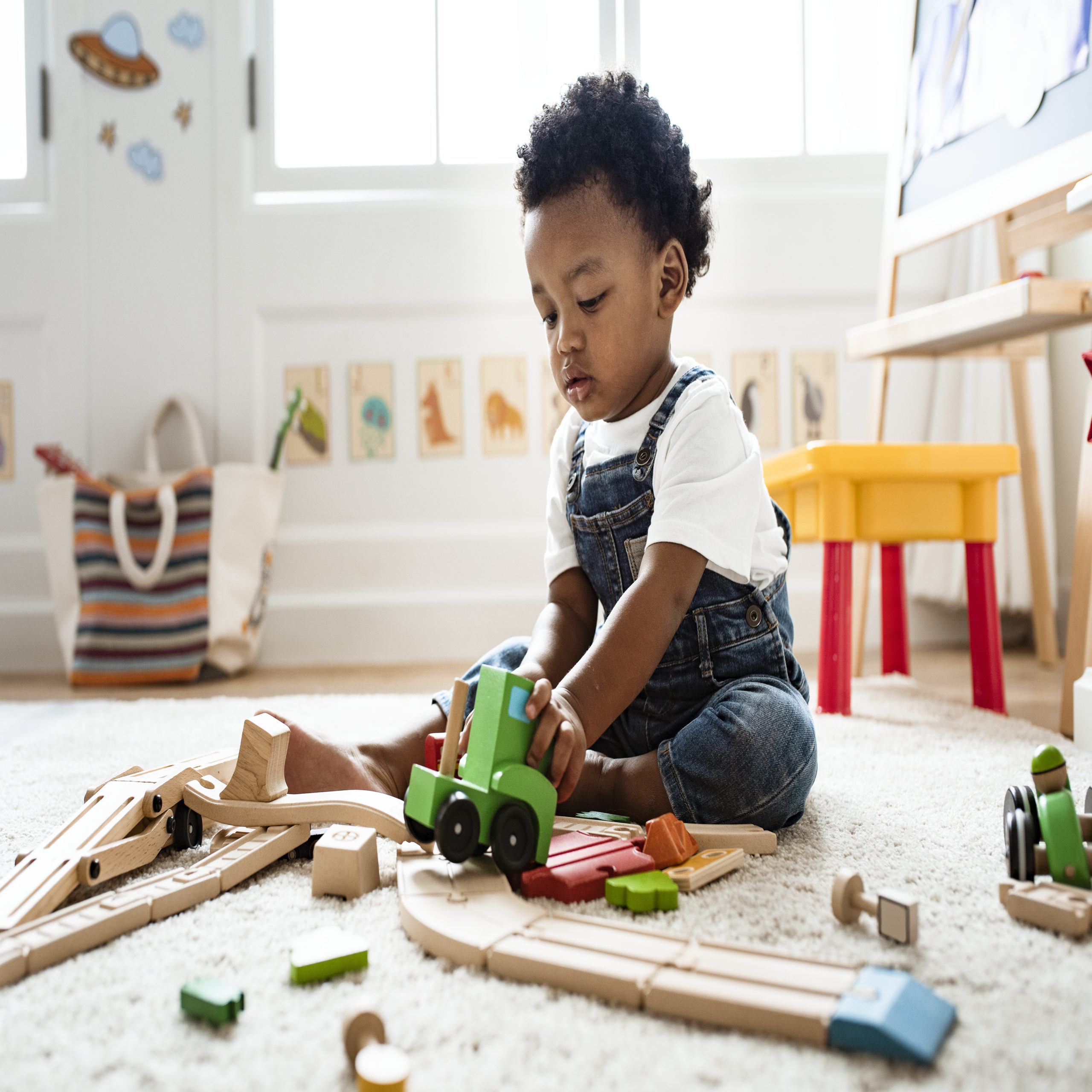 toddler playing with toys on the floor