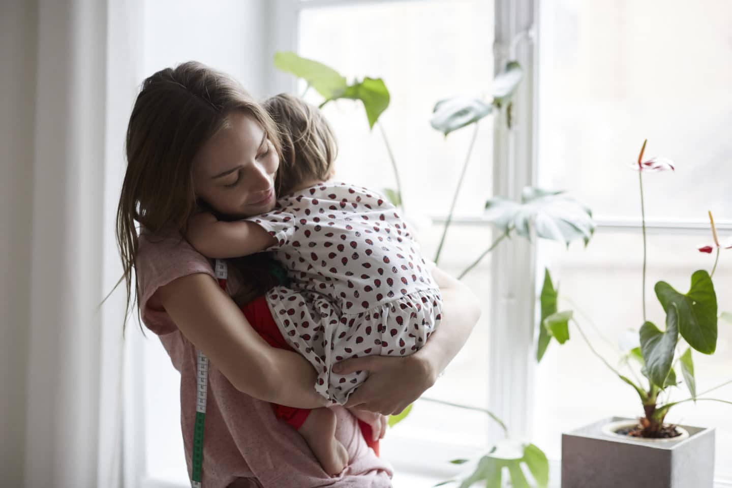 mom holding toddler against her shoulder