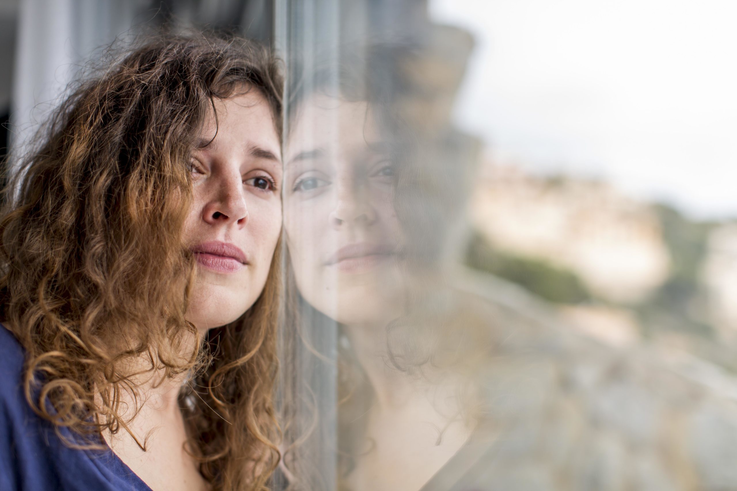 woman looking out window