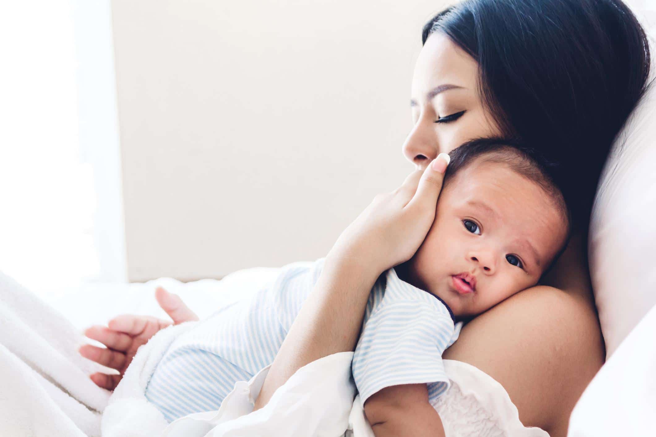 mom holding baby against her shoulder