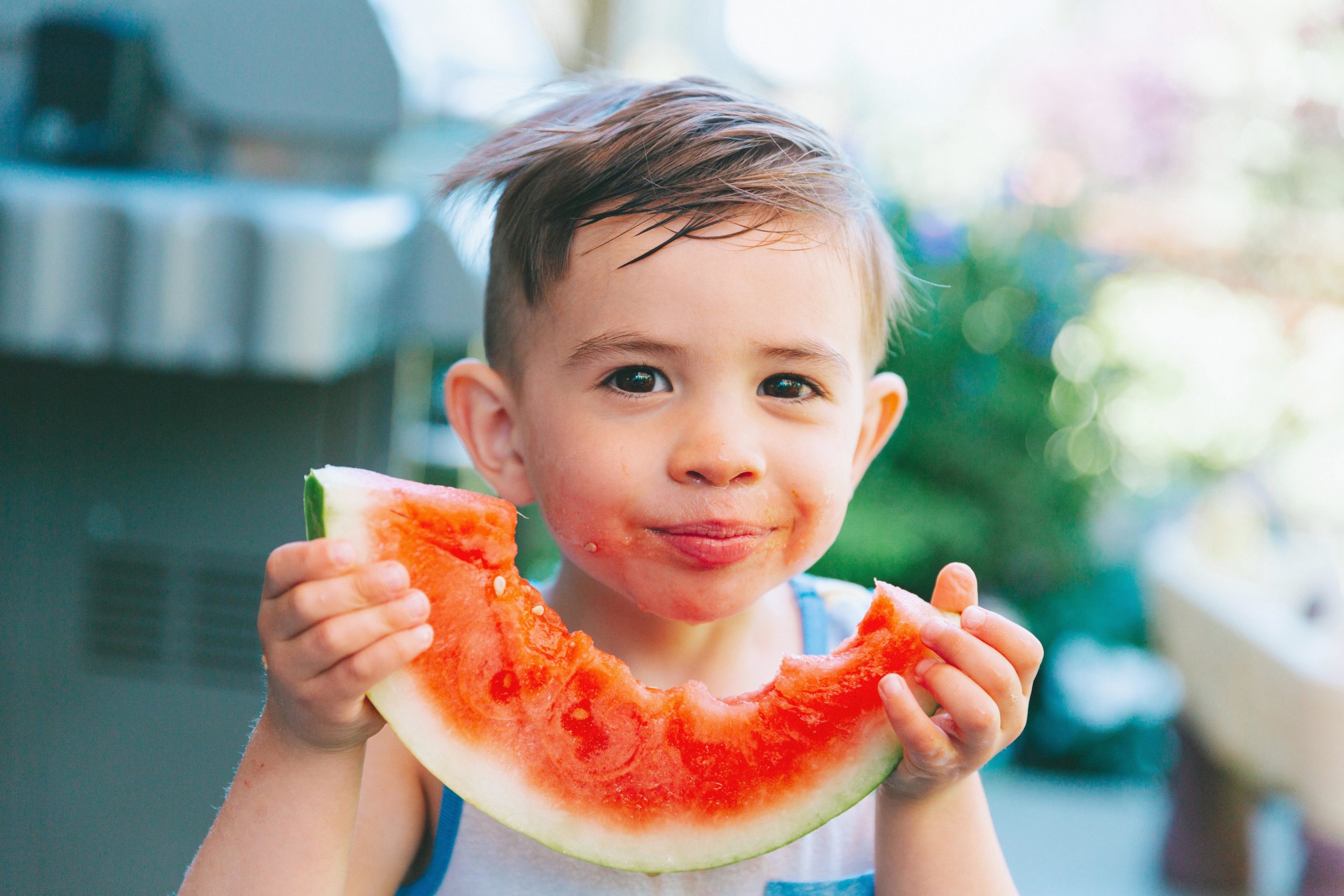 little boy eating watermelon- july baby names