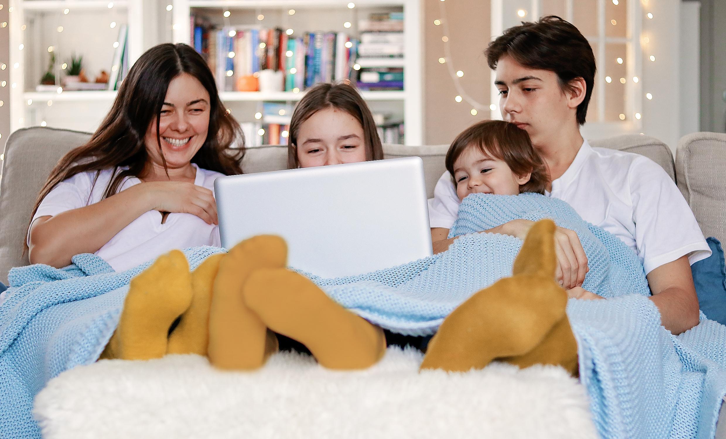 family watching a movie together on a laptop