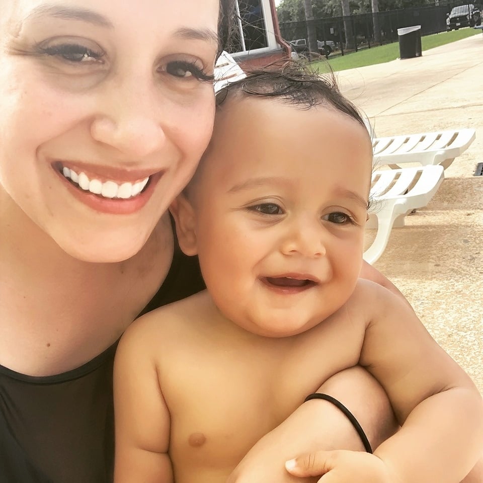 woman taking a selfie with her son at the pool