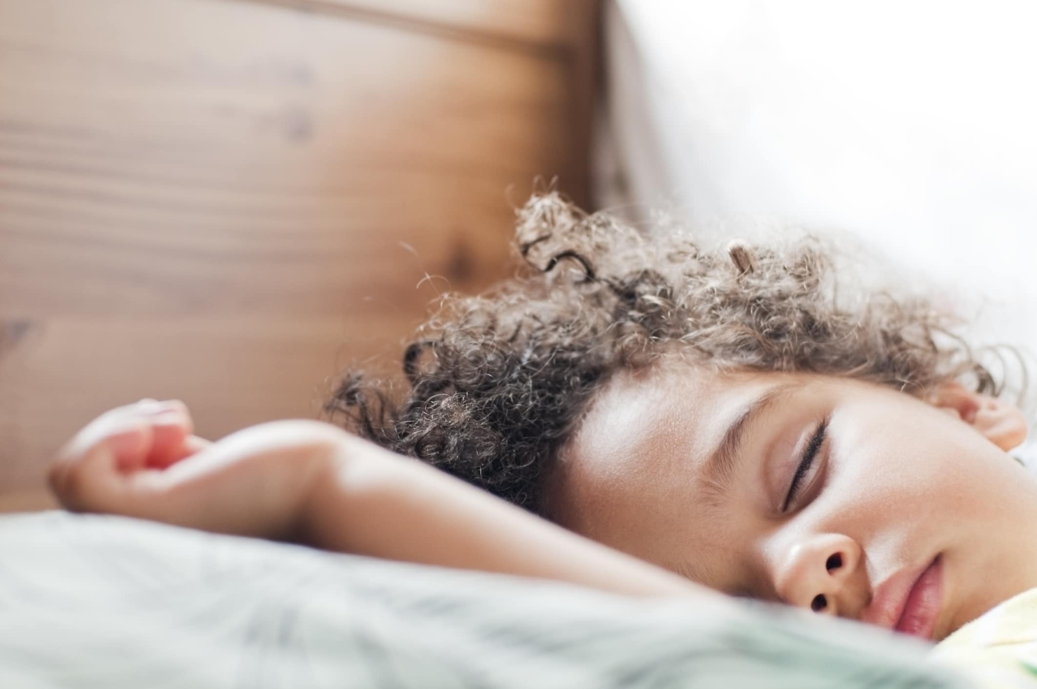 little boy sleeping in bed