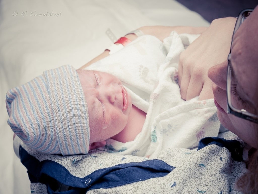 mom holding newborn baby after birth