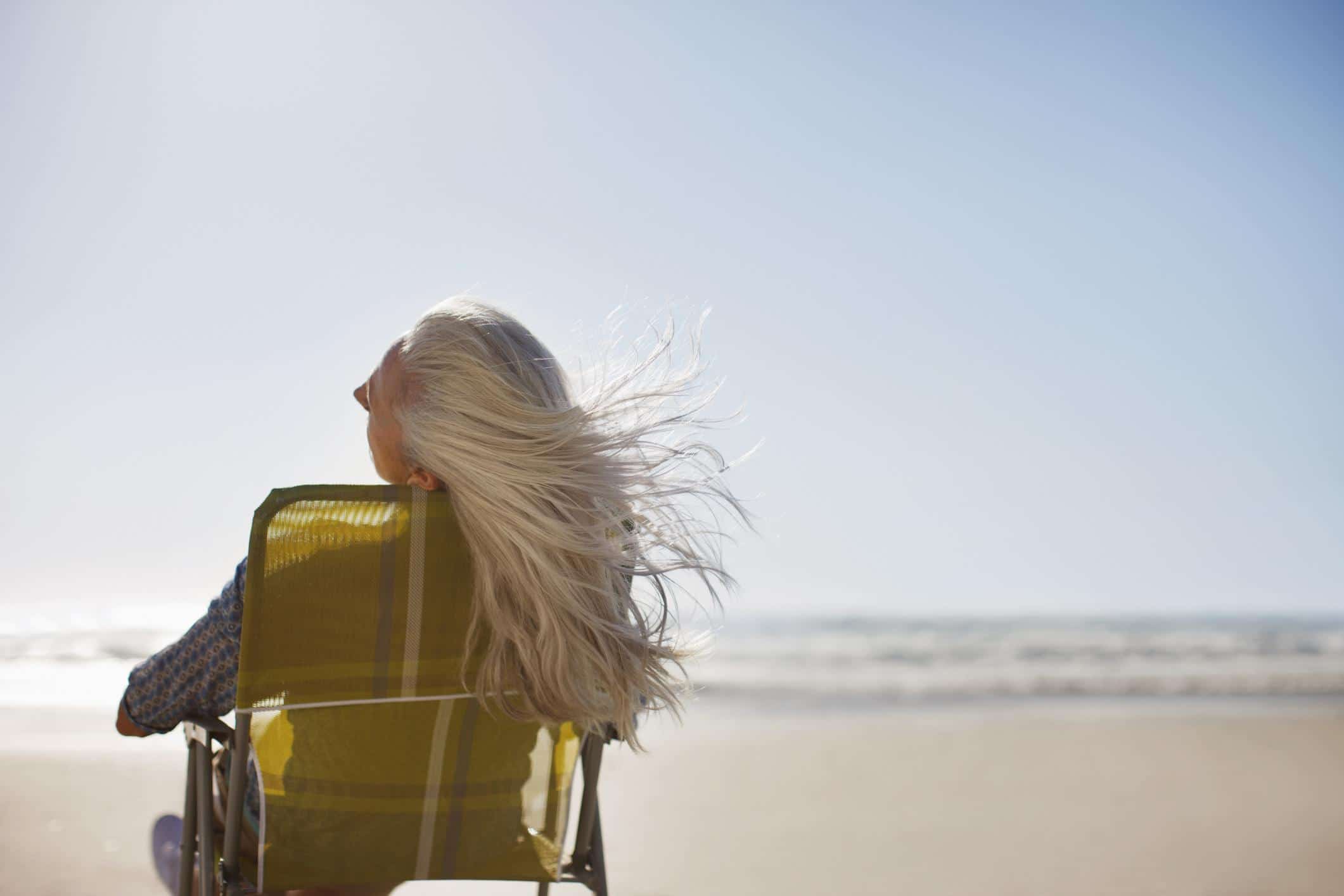 woman with hair flowing in the wind on a beach