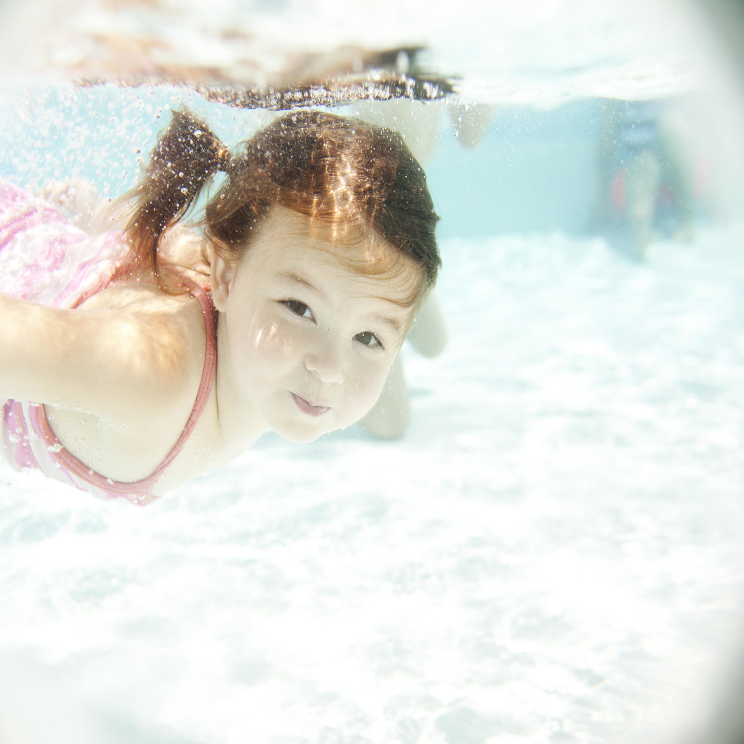 little girl swimming in a pool