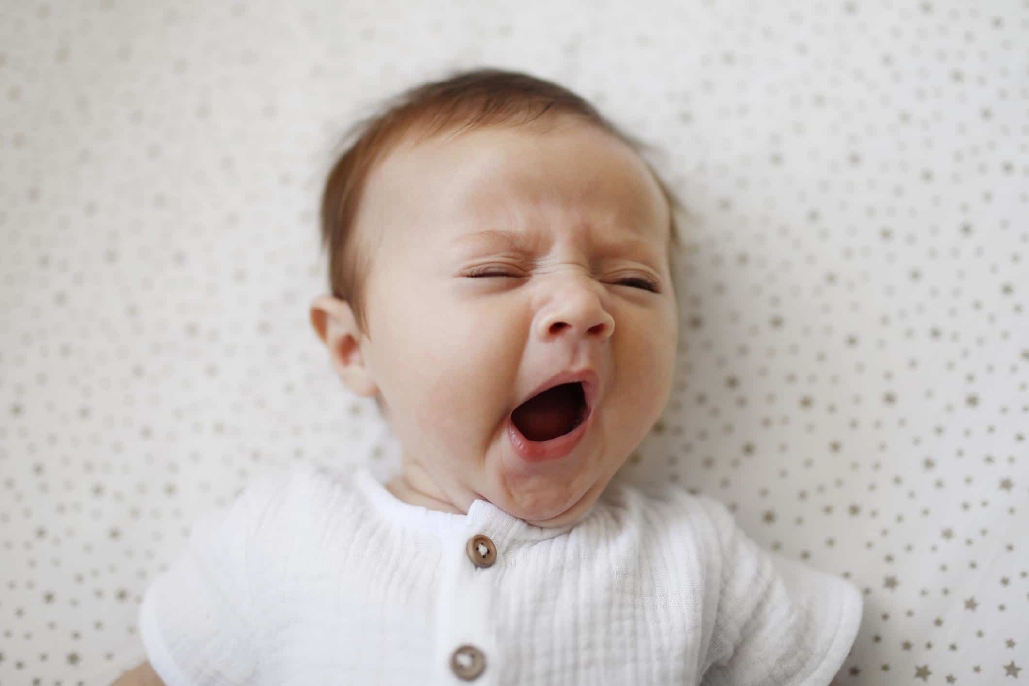 three-week-old baby yawning