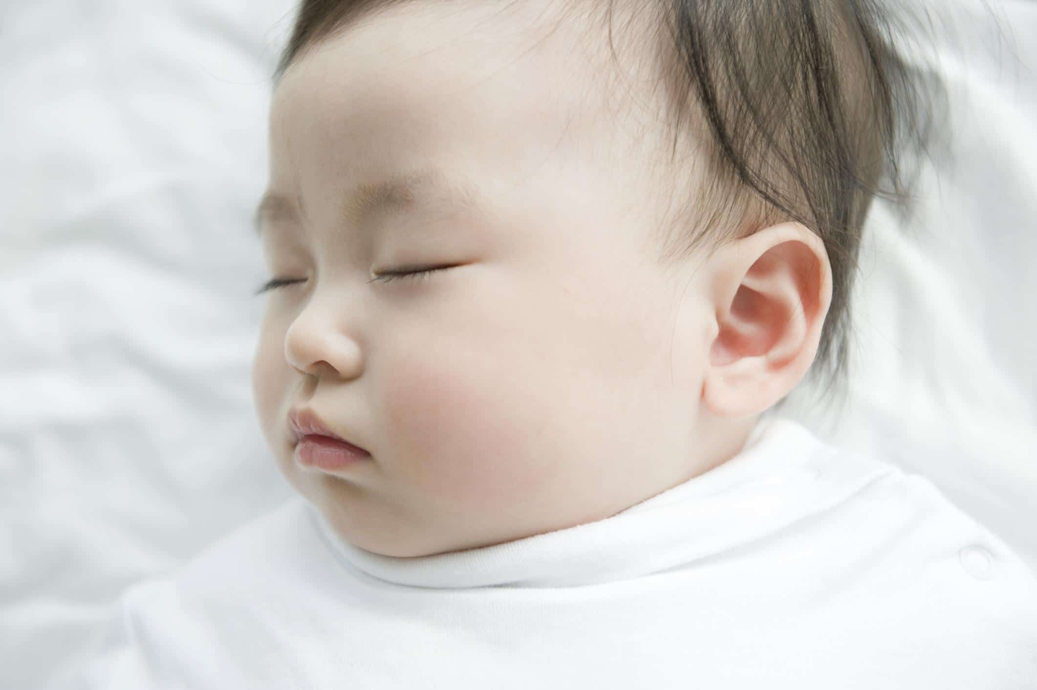 12-week-old baby sleeping on its back