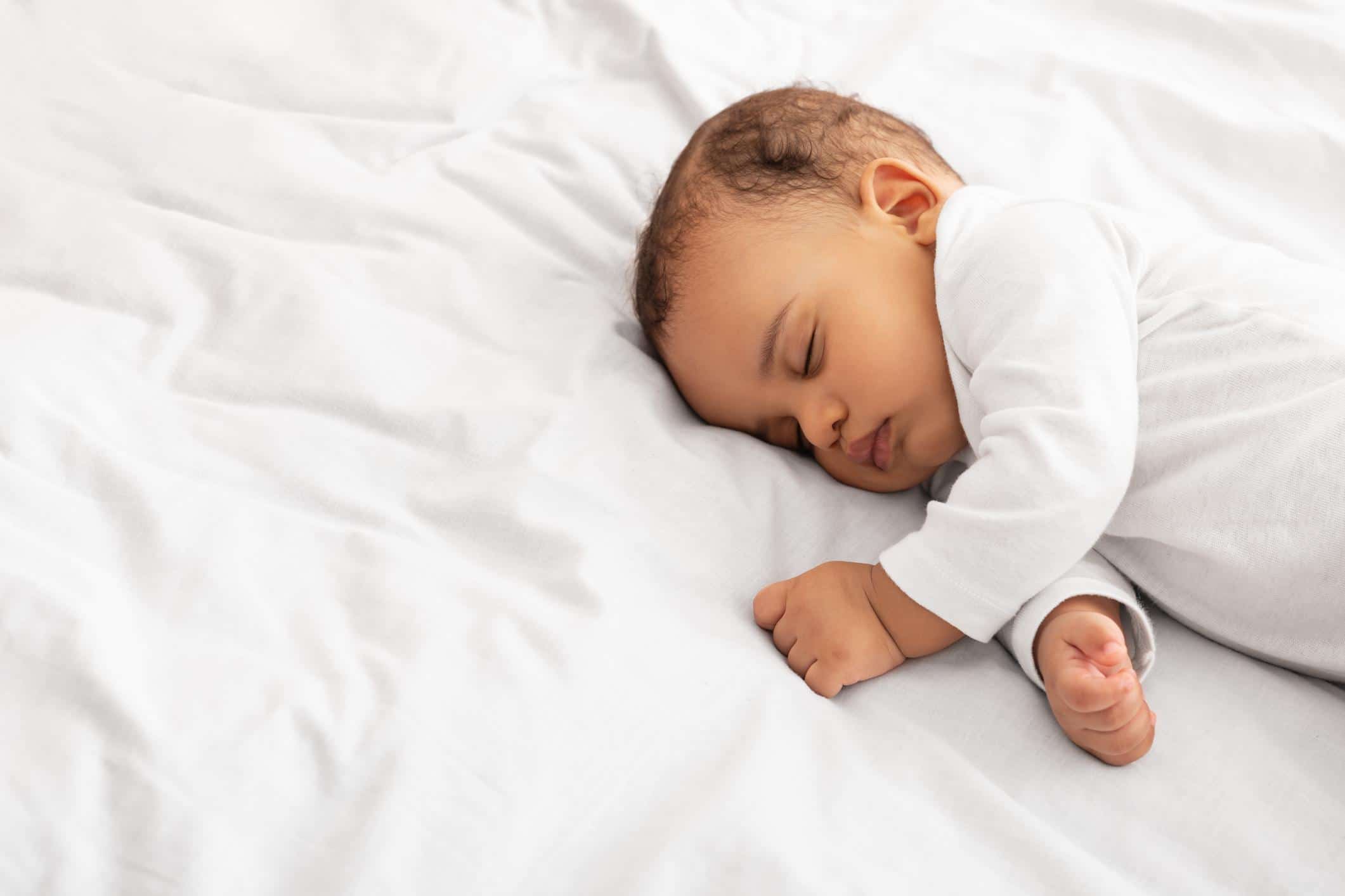 11-week-old baby sleeping on its side