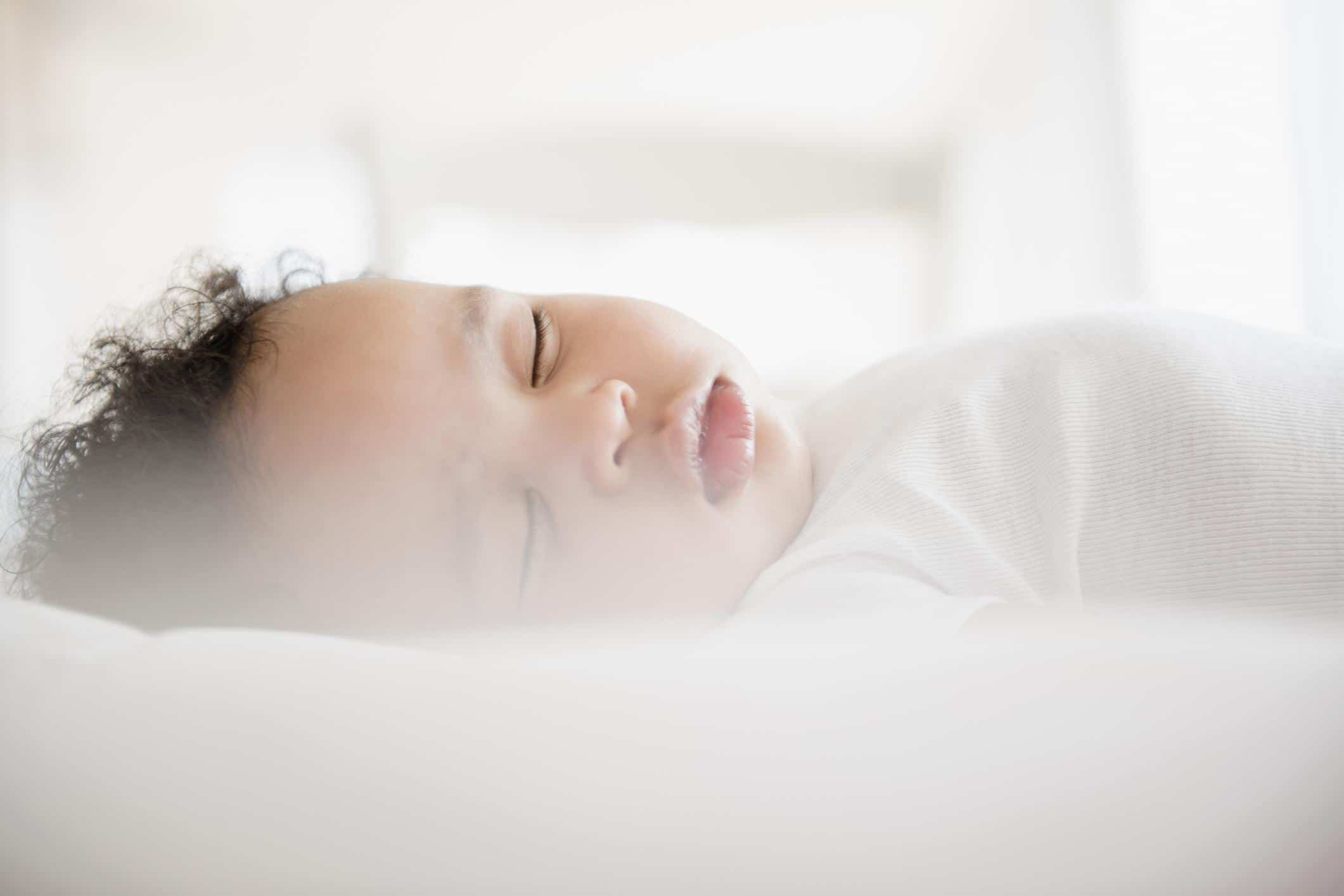 nine-week-old baby sleeping in a crib