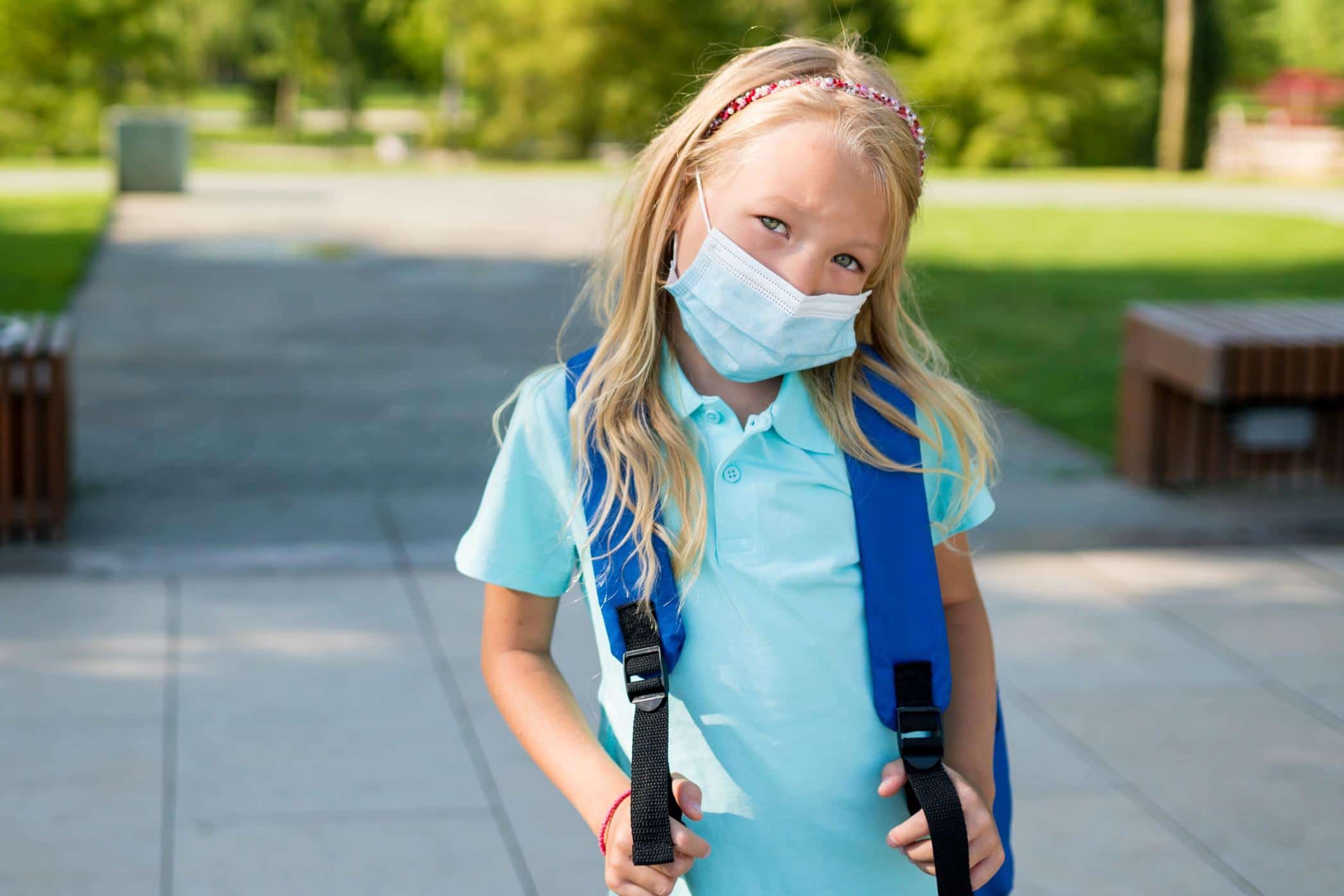 child wearing a mask at school