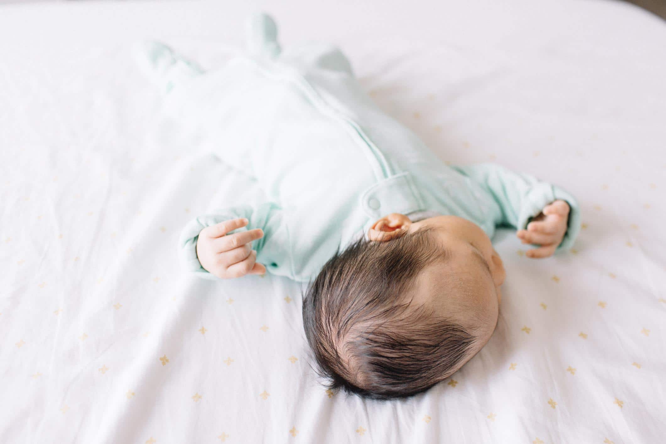 4-month-old baby sleeping in a crib