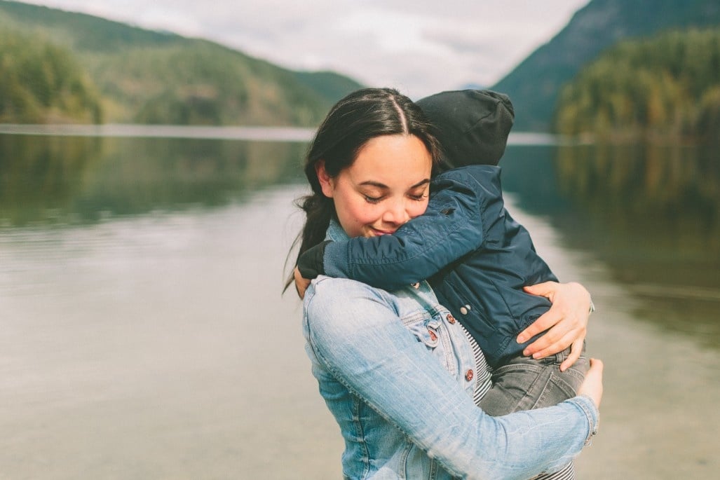 mom hugging toddler boy