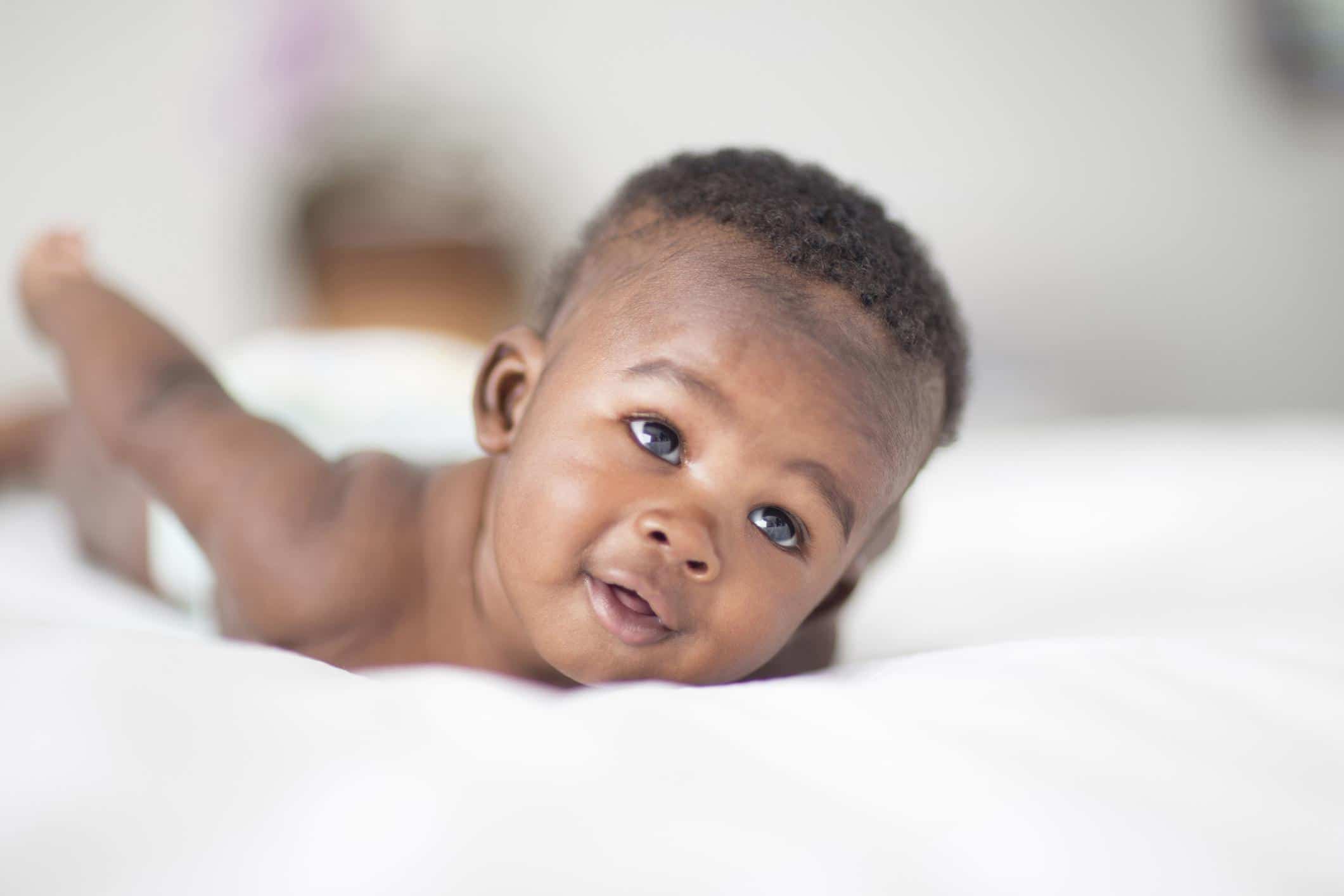 baby boy doing tummy time- September baby names