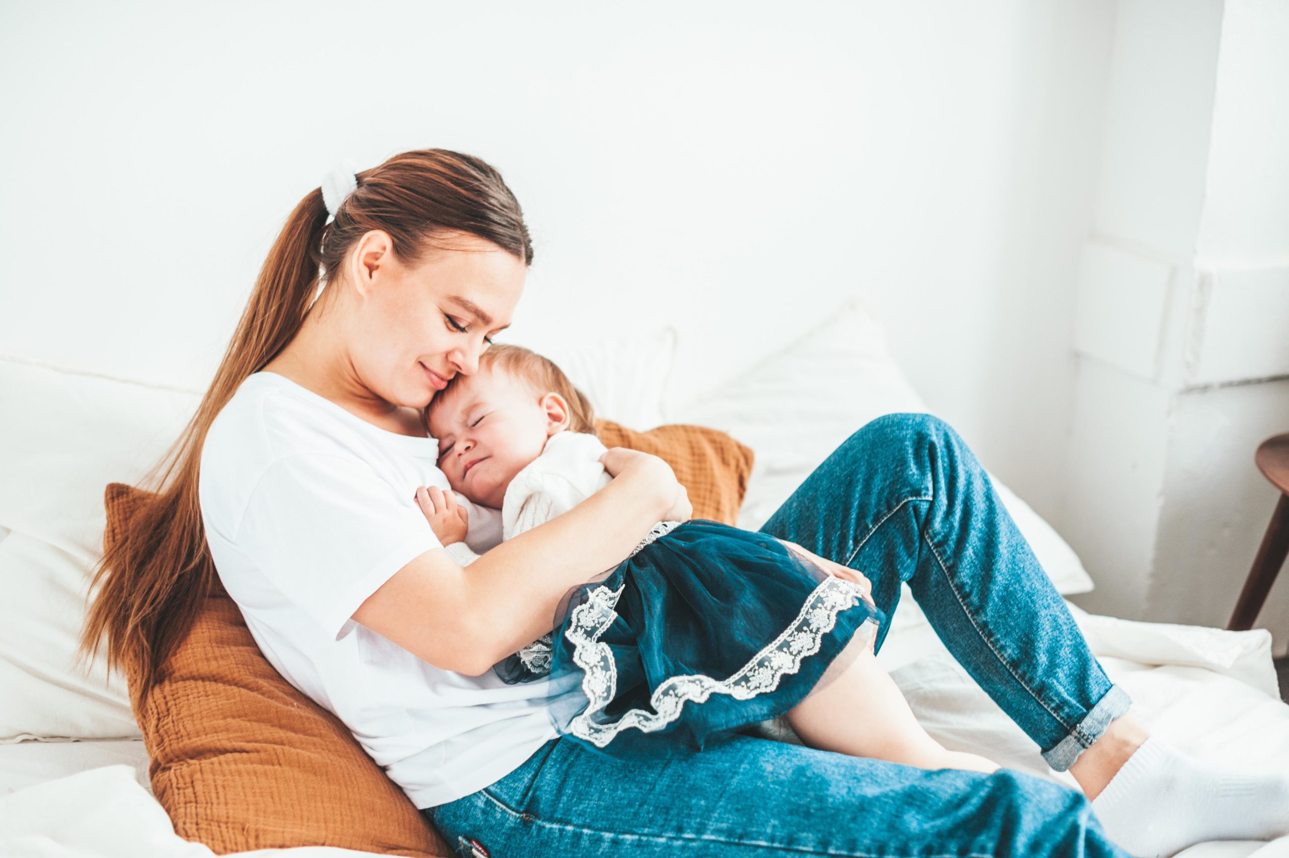 paid leave: mother holding baby at home