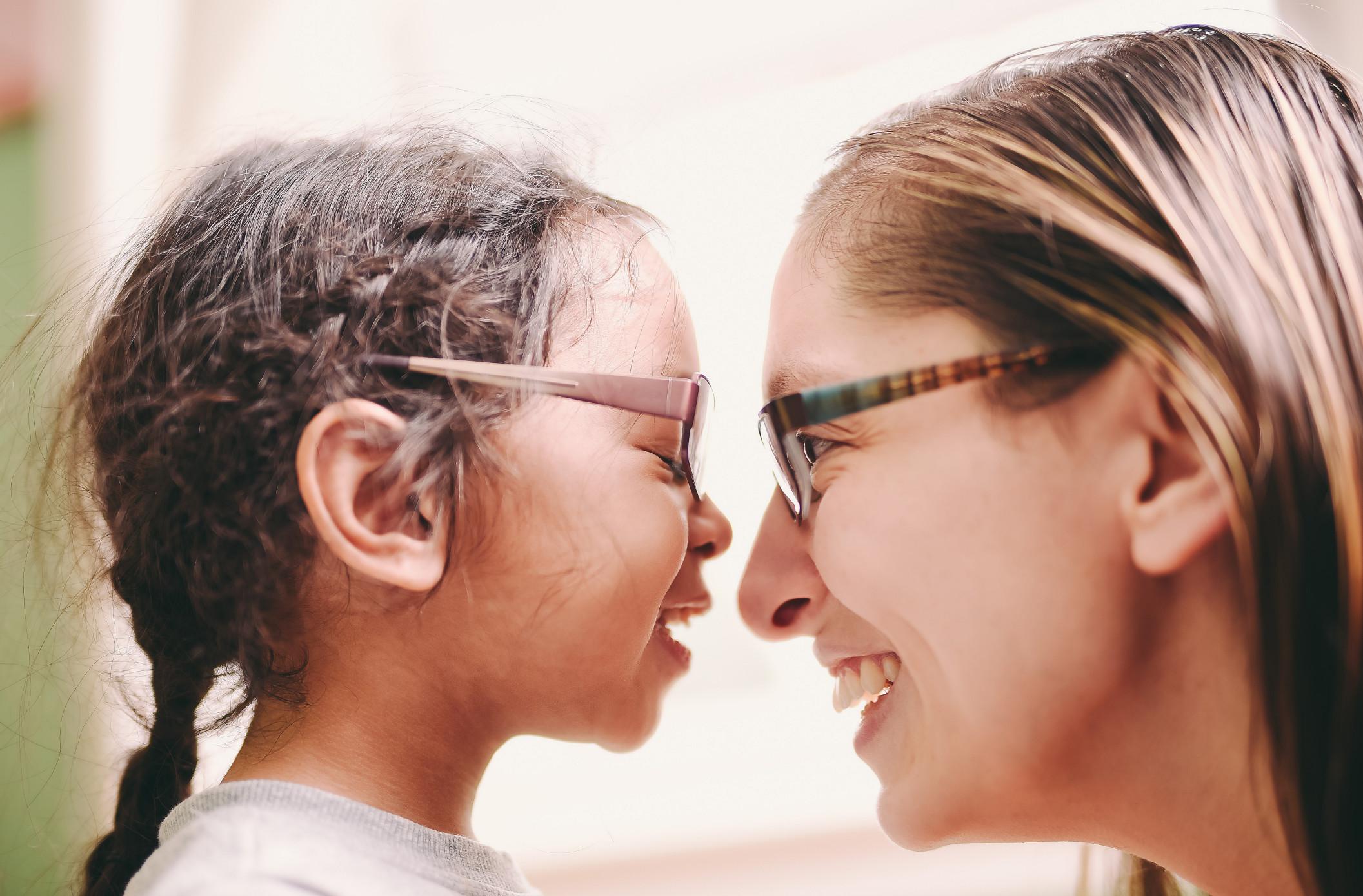 mom face-to-face smiling at daughter