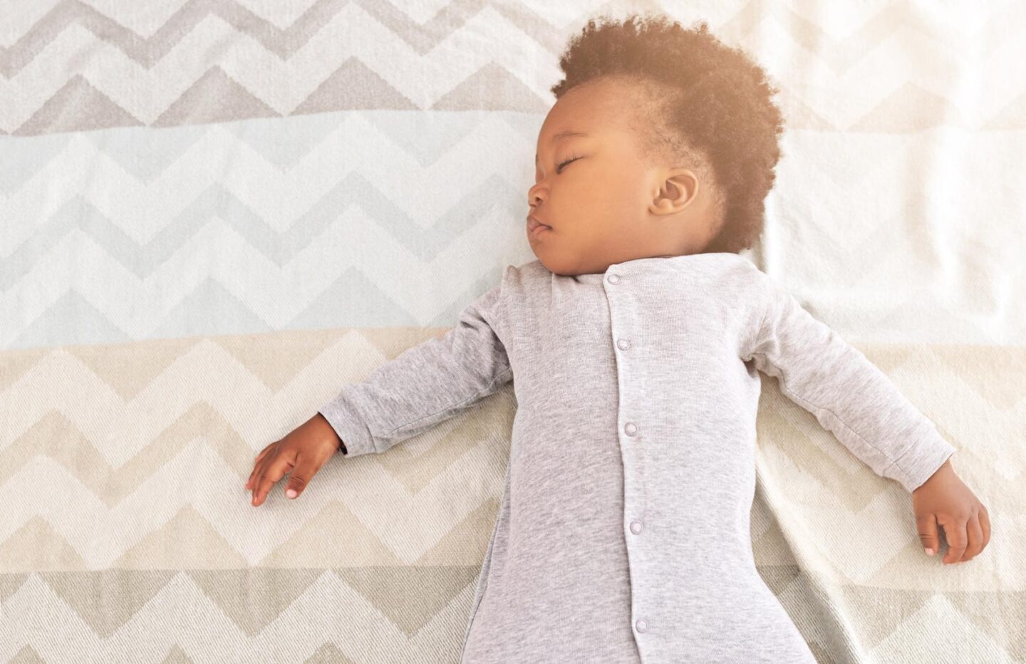 nine-month-old baby sleeping in a crib