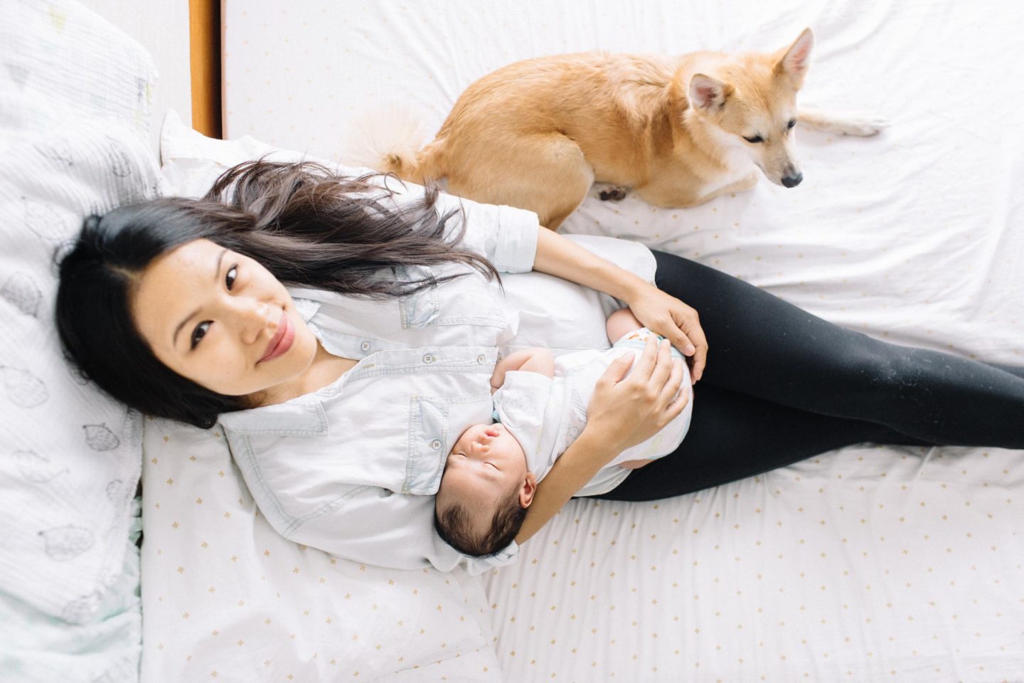 mom holding baby and looking at camera